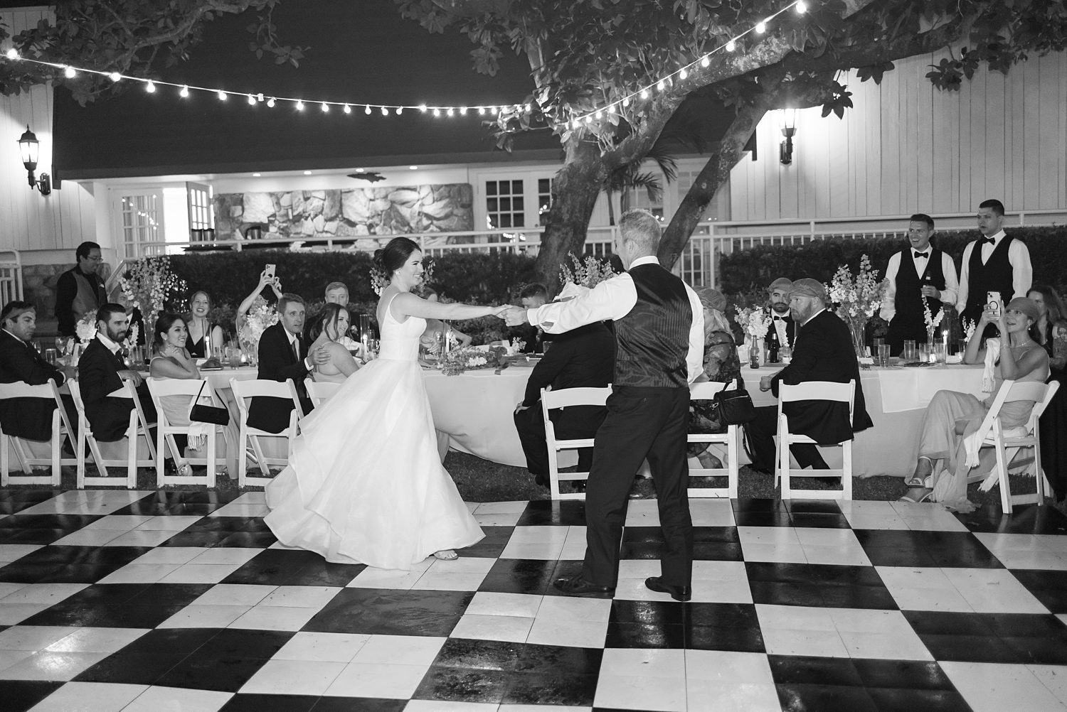 groom twirls out bride on dance floor at open air reception at Innisbrook Resort