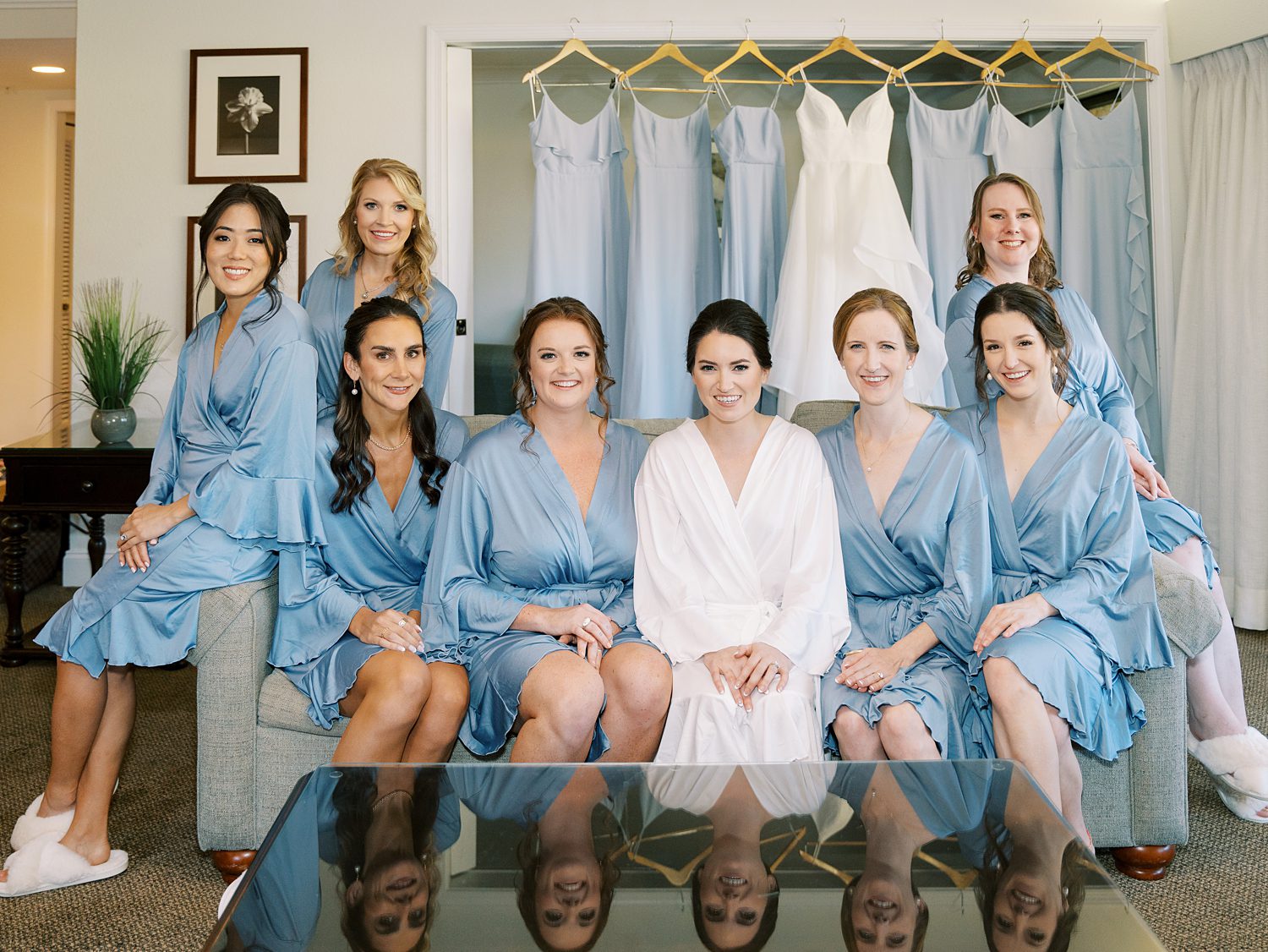 bride sits with bridesmaids in Patel blue robes at open air reception at Innisbrook Resort
