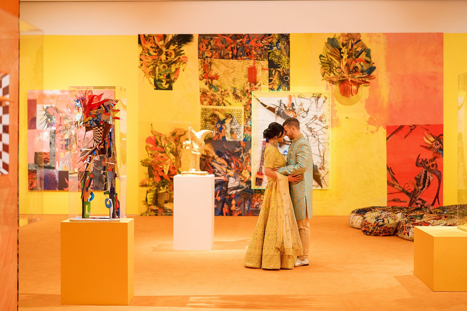 husband and wife hug in colorful artwork gallery at the Tampa Museum of Art