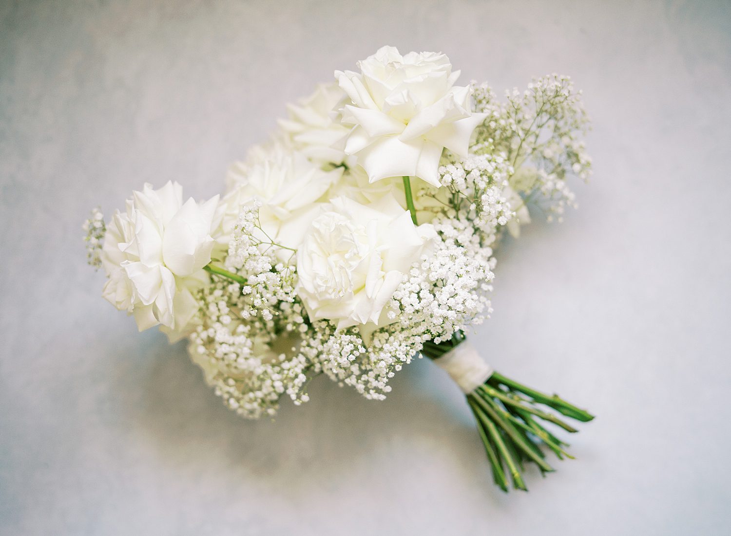 bride's bouquet of white roses and baby's breath 