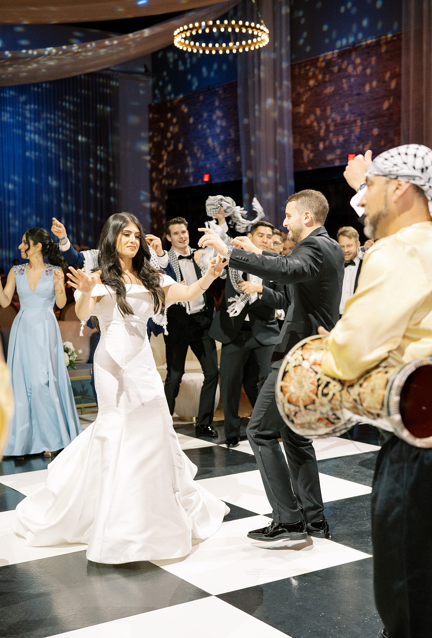 bride and groom dance with Palestinan band around 