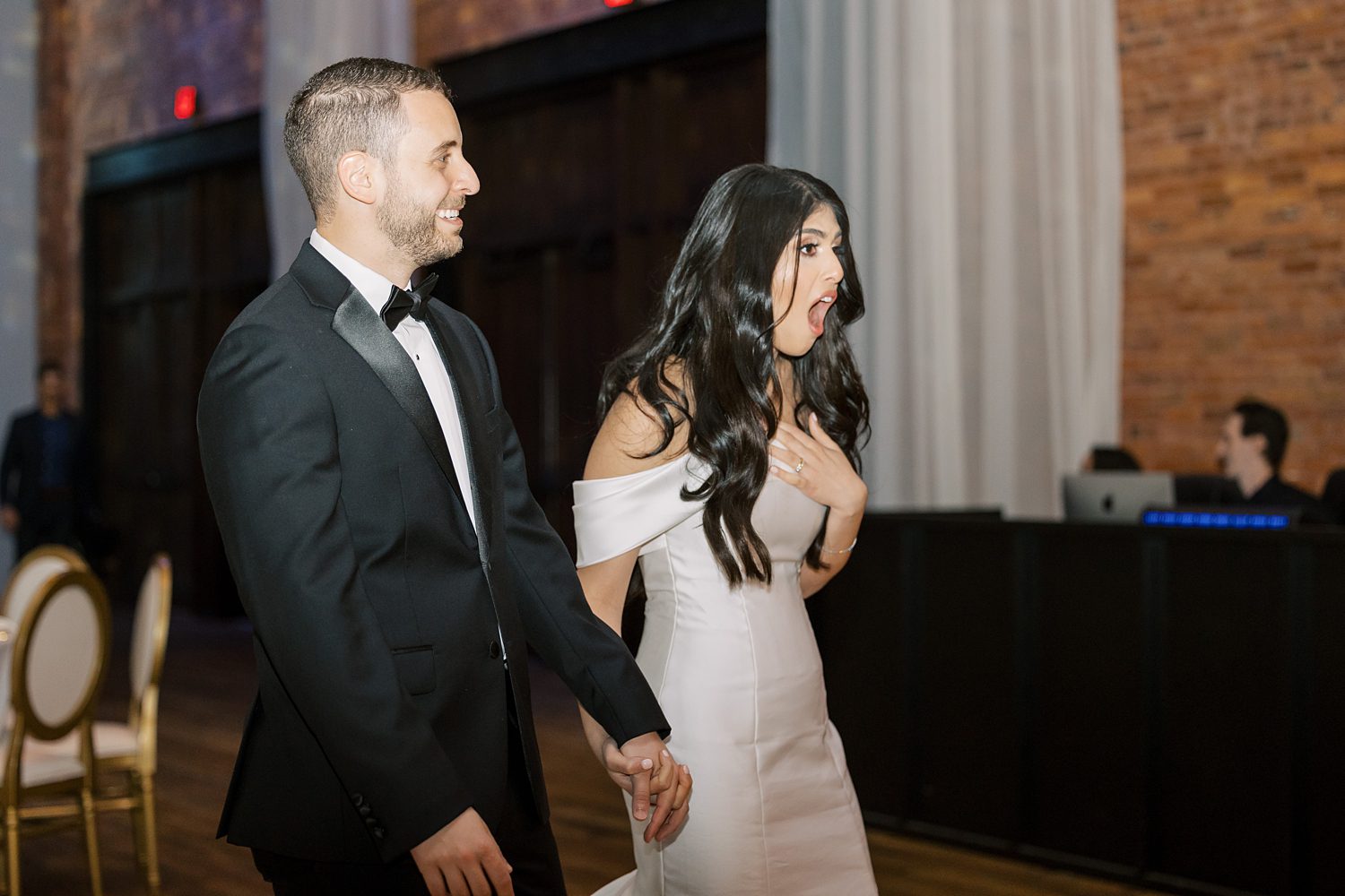 bride and groom react to seeing Armature Works wedding reception setup 