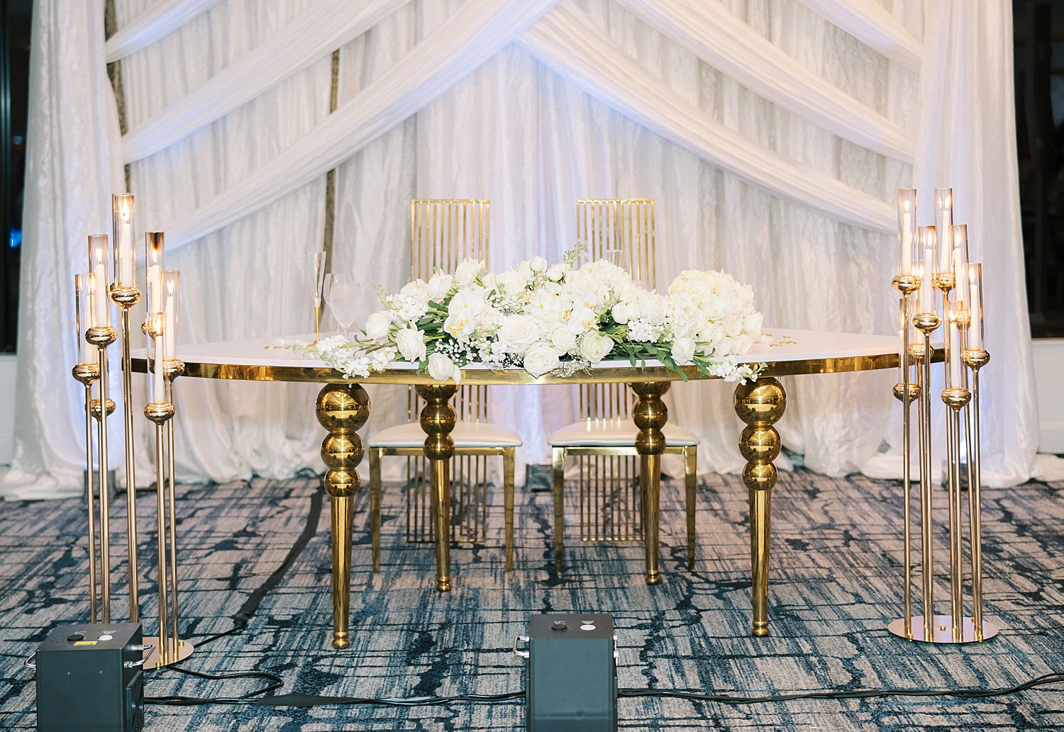 sweetheart table with candles and ivory flowers in center for Rusty Pelican Tampa wedding reception