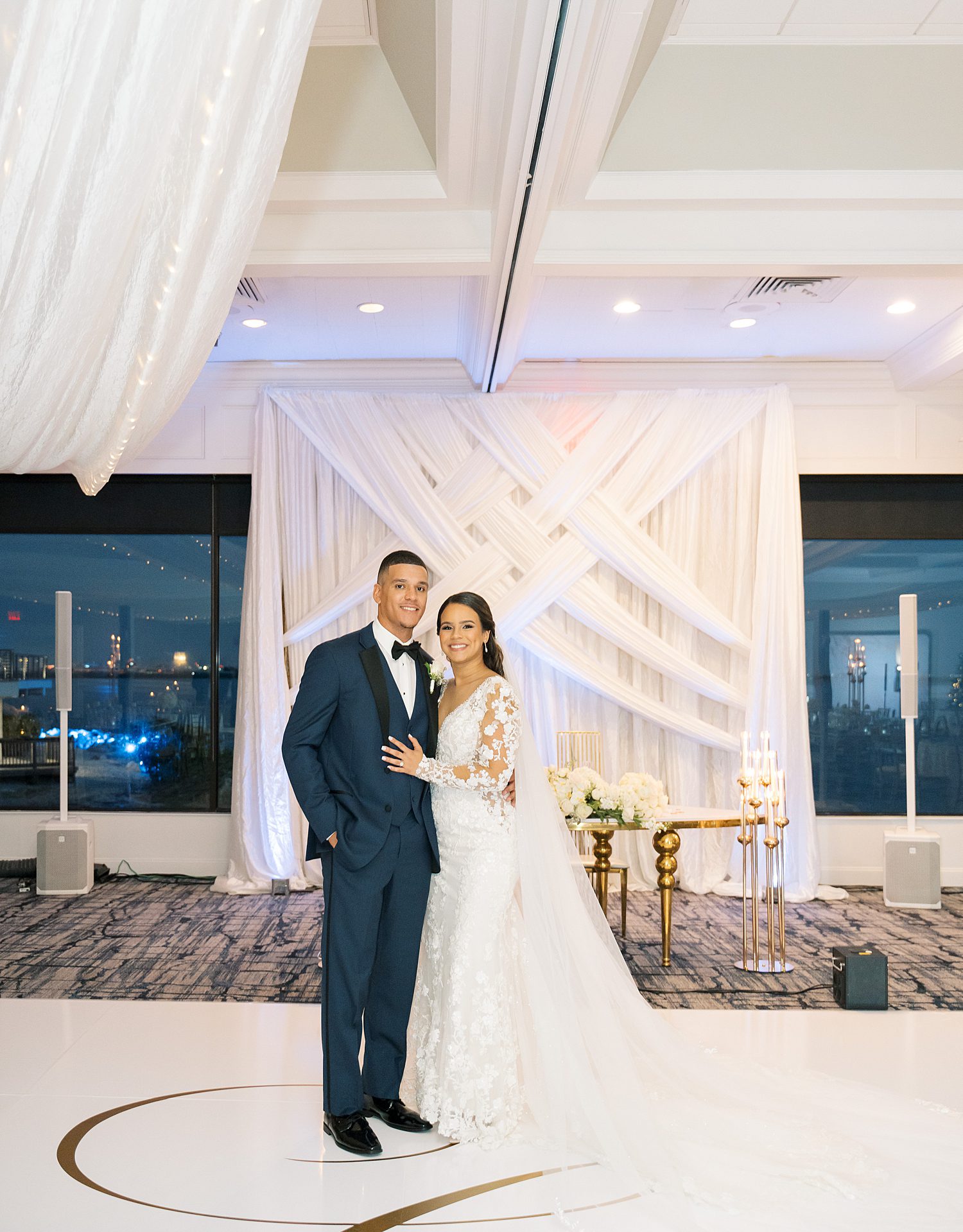 bride and groom pose on dance floor inside Rusty Pelican Tampa wedding reception 
