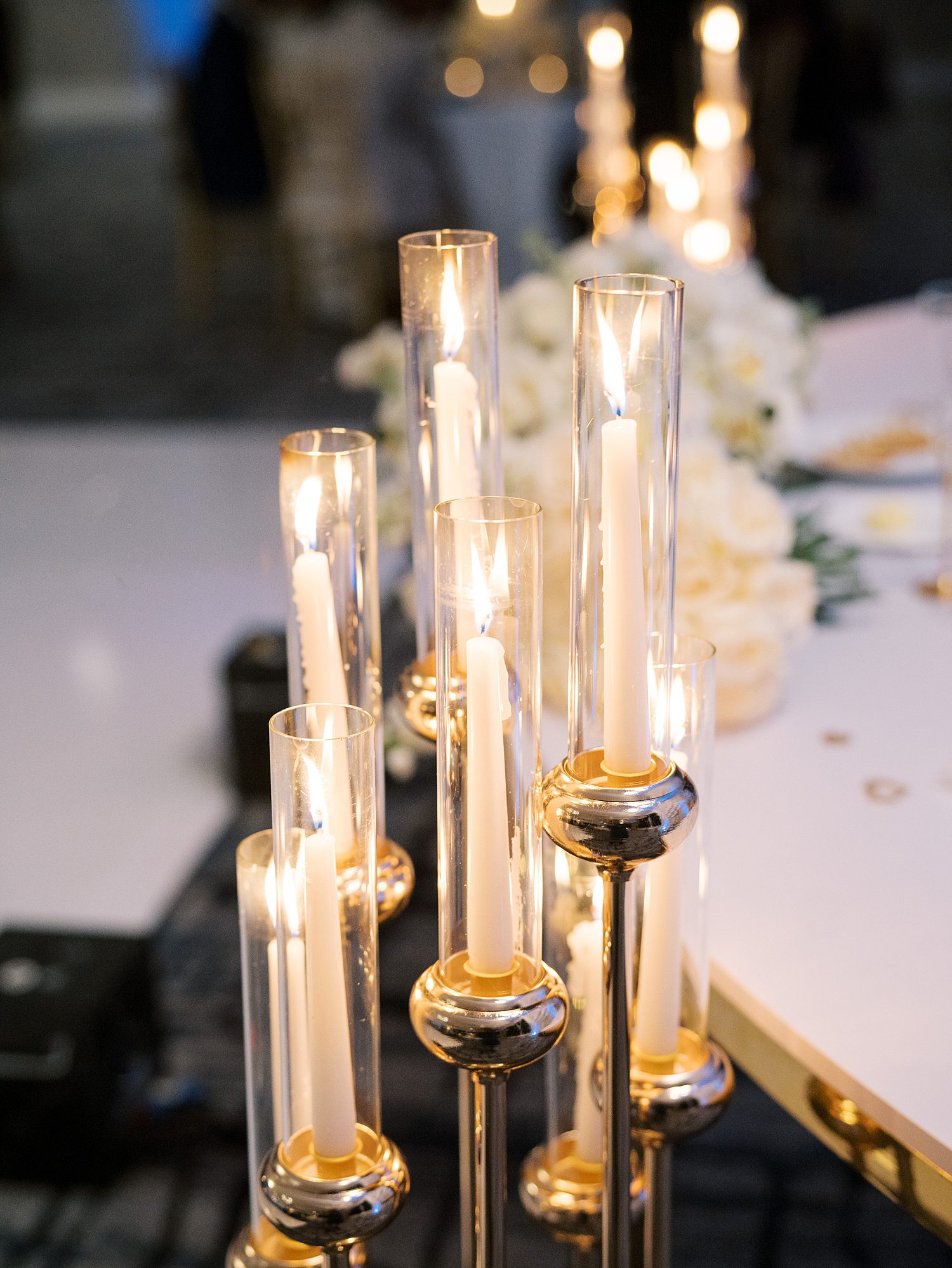 tapered candles in glass holders on tables for Rusty Pelican Tampa wedding reception