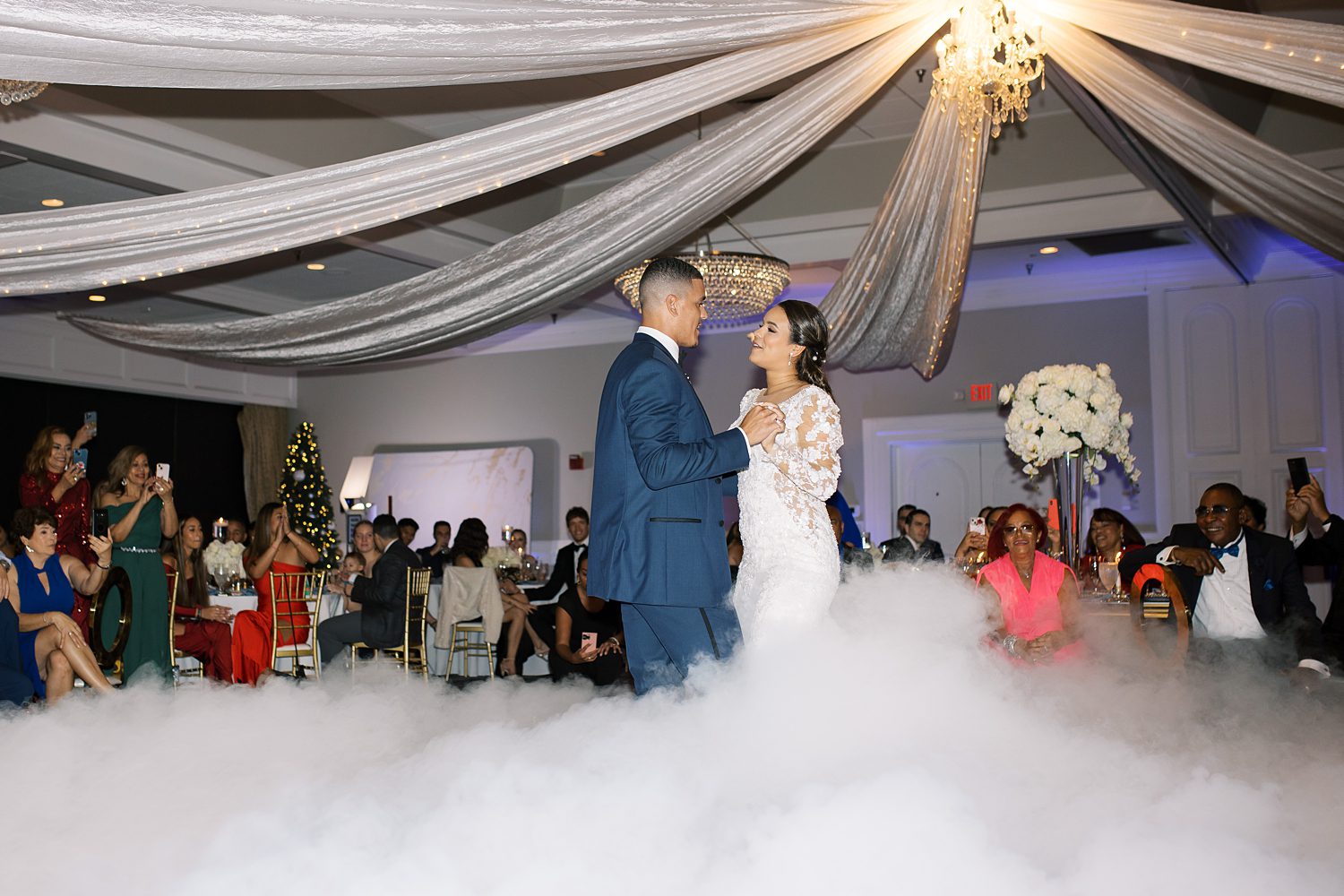 bride and groom have first dance during Rusty Pelican Tampa wedding reception in fog and mist 