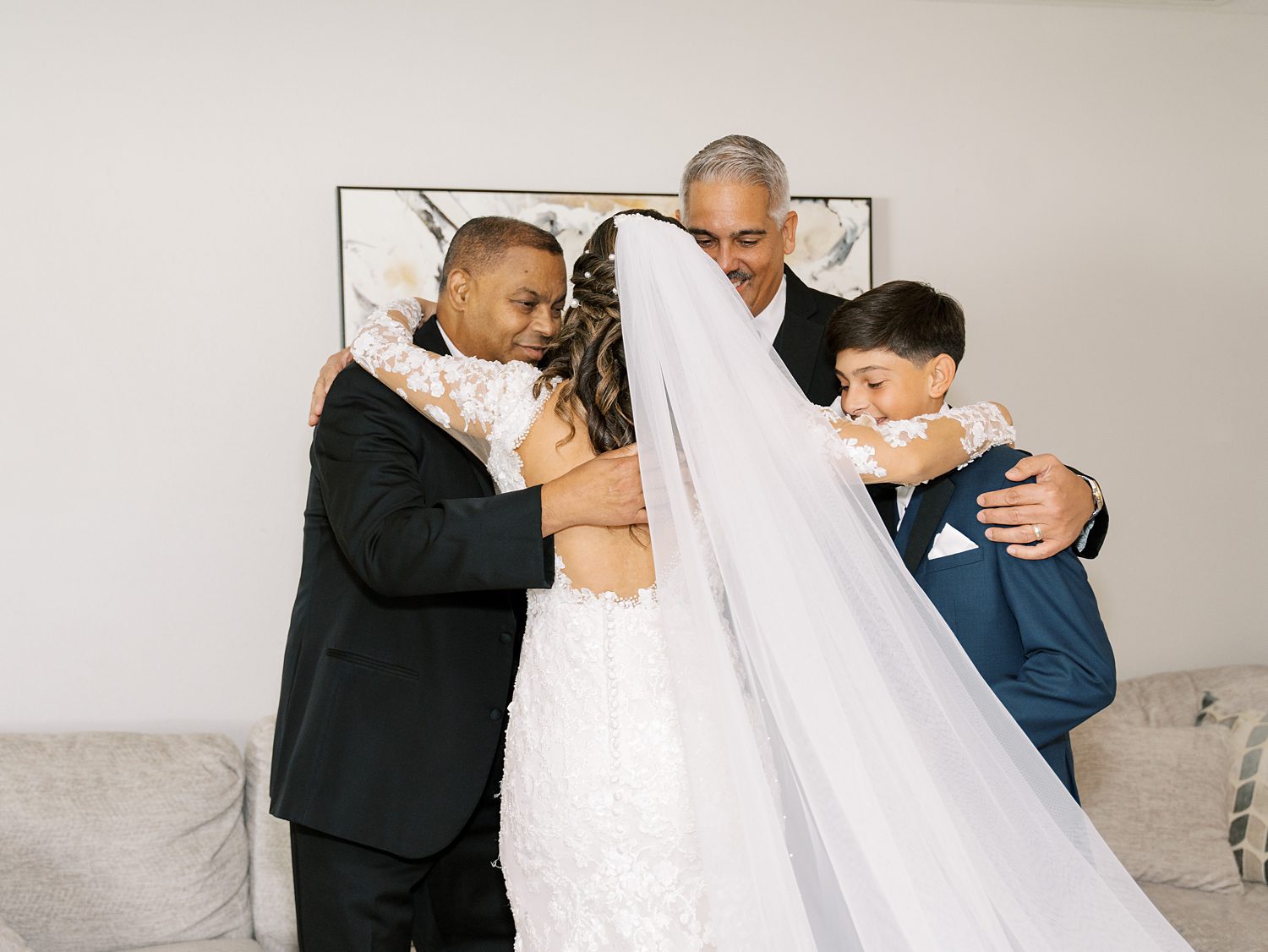 bride has emotional first look with brothers and father
