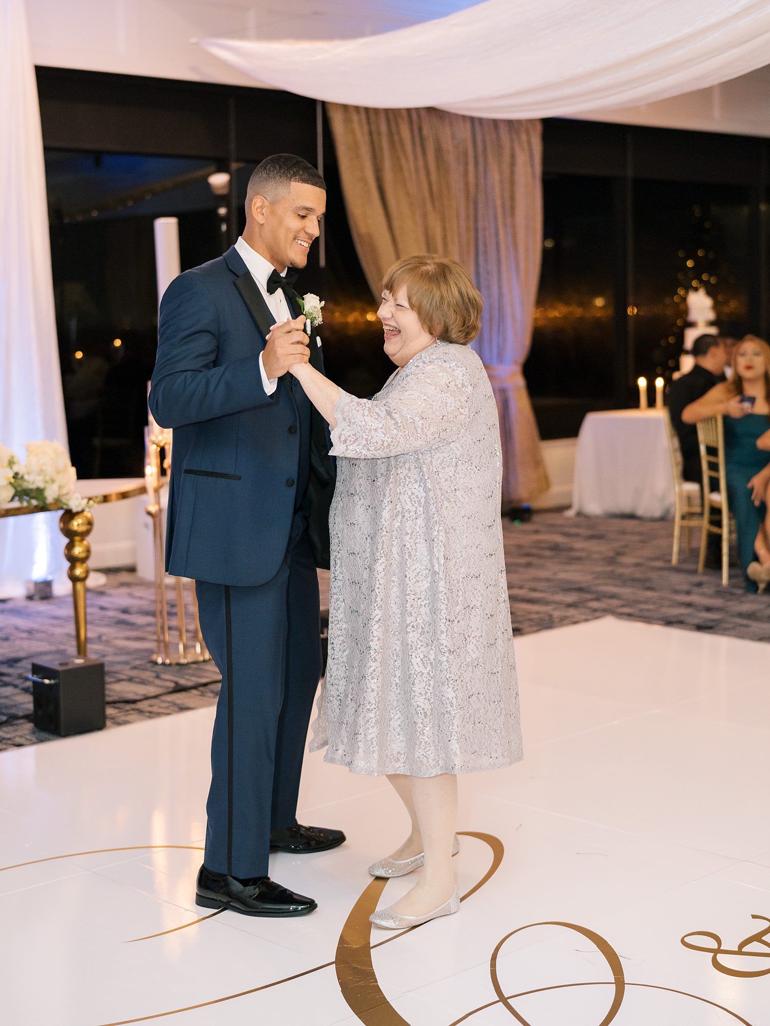 groom dances with mother during Rusty Pelican Tampa wedding reception