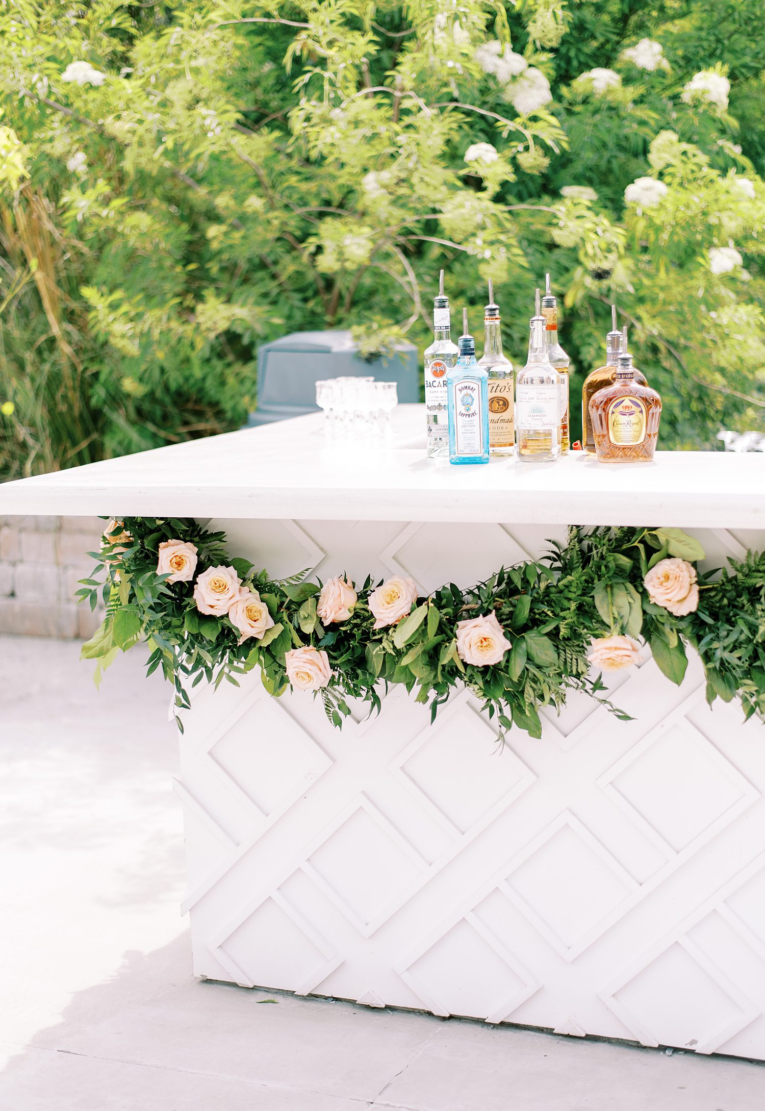 outdoor bar at Mill Pond Estate wedding with rose garland 