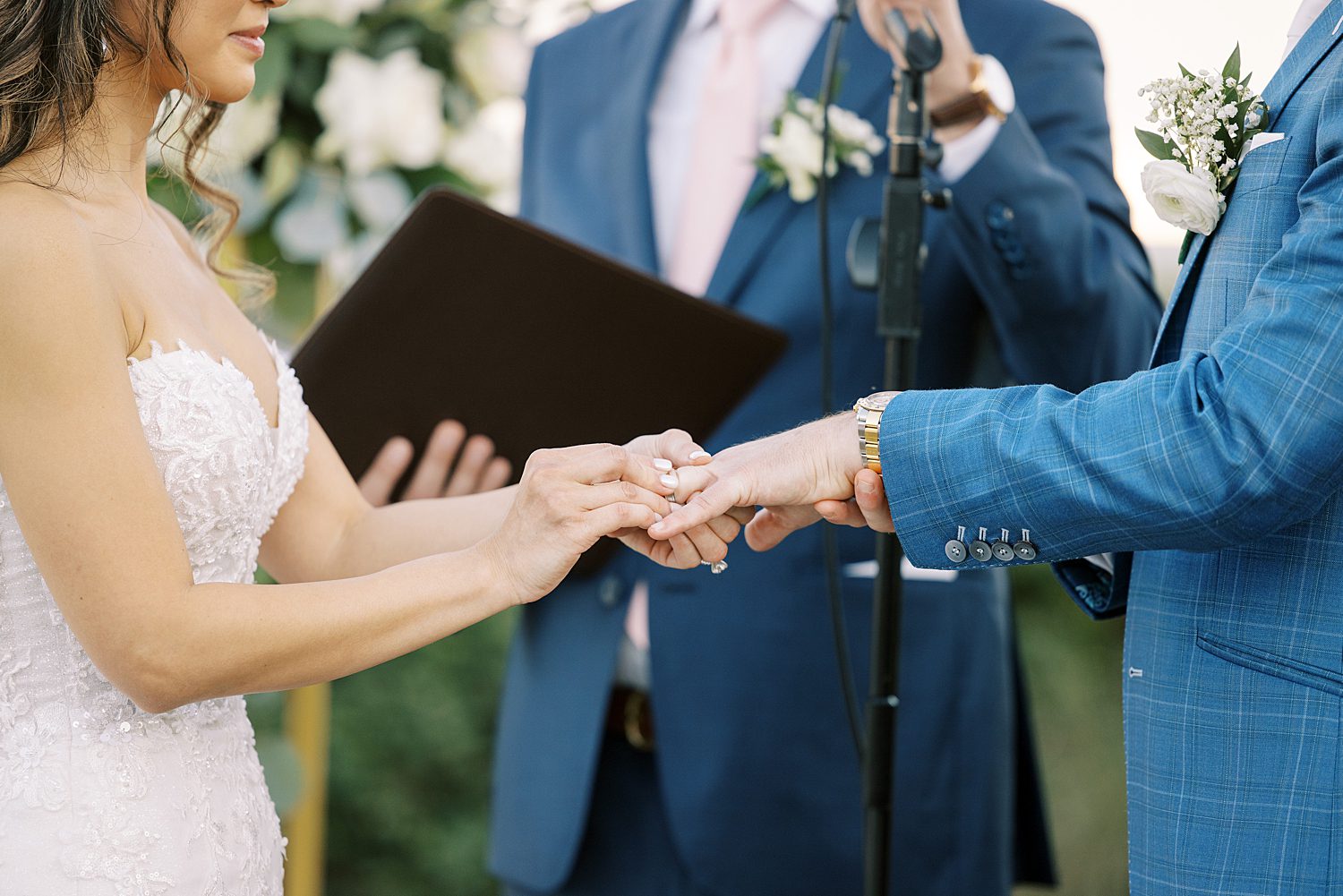 bride places ring on groom's finger during ceremony at Tampa Yacht Club