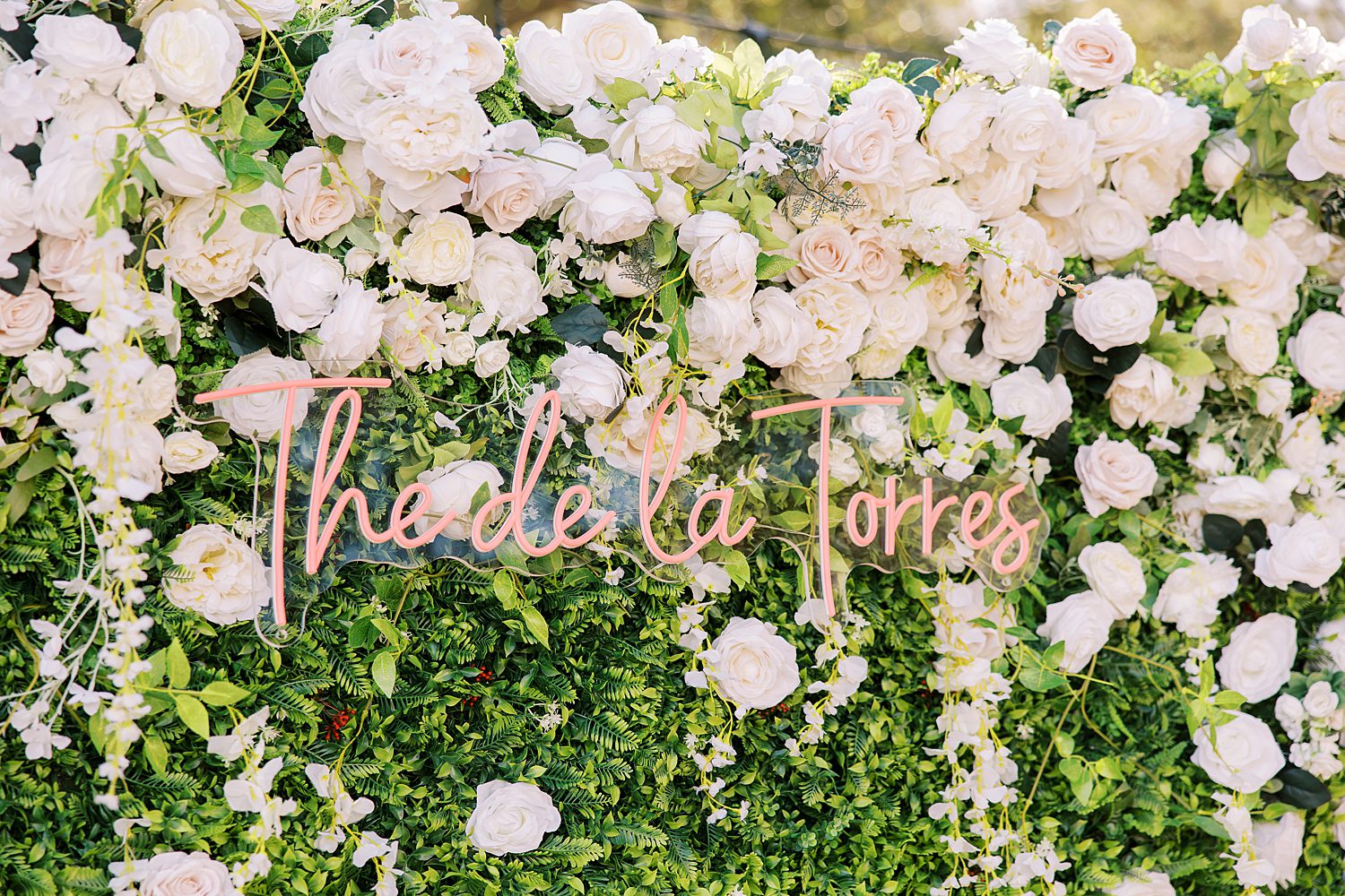 flower wall with custom neon sign for Tampa wedding reception 