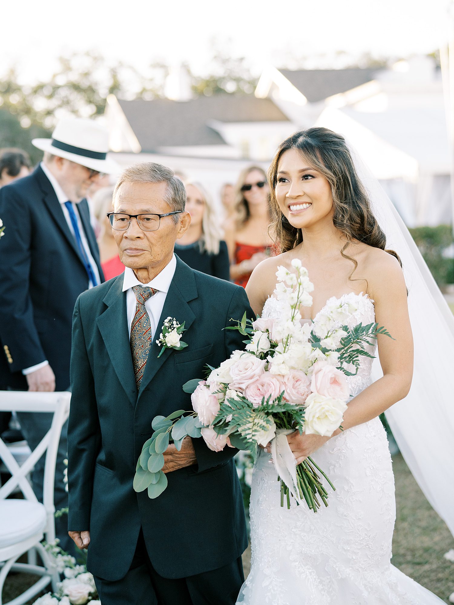 bride walks down aisle with father on lawn at Tampa Yacht Club