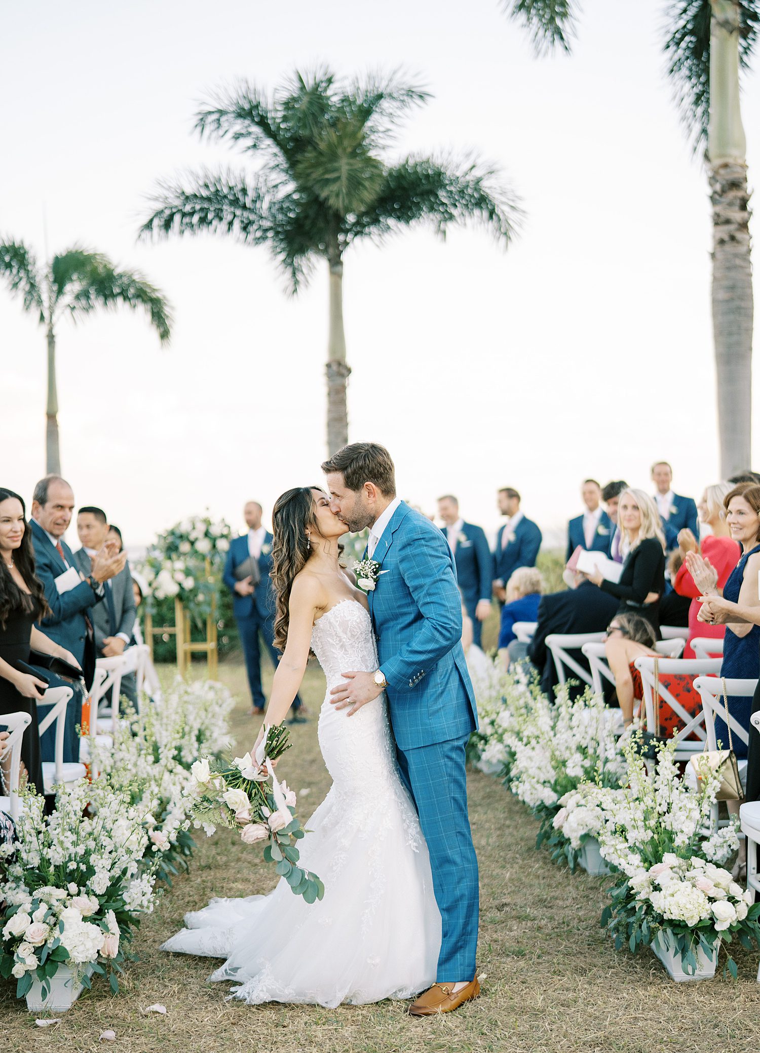 newlyweds kiss at end of aisle after ceremony at Tampa Yacht Club