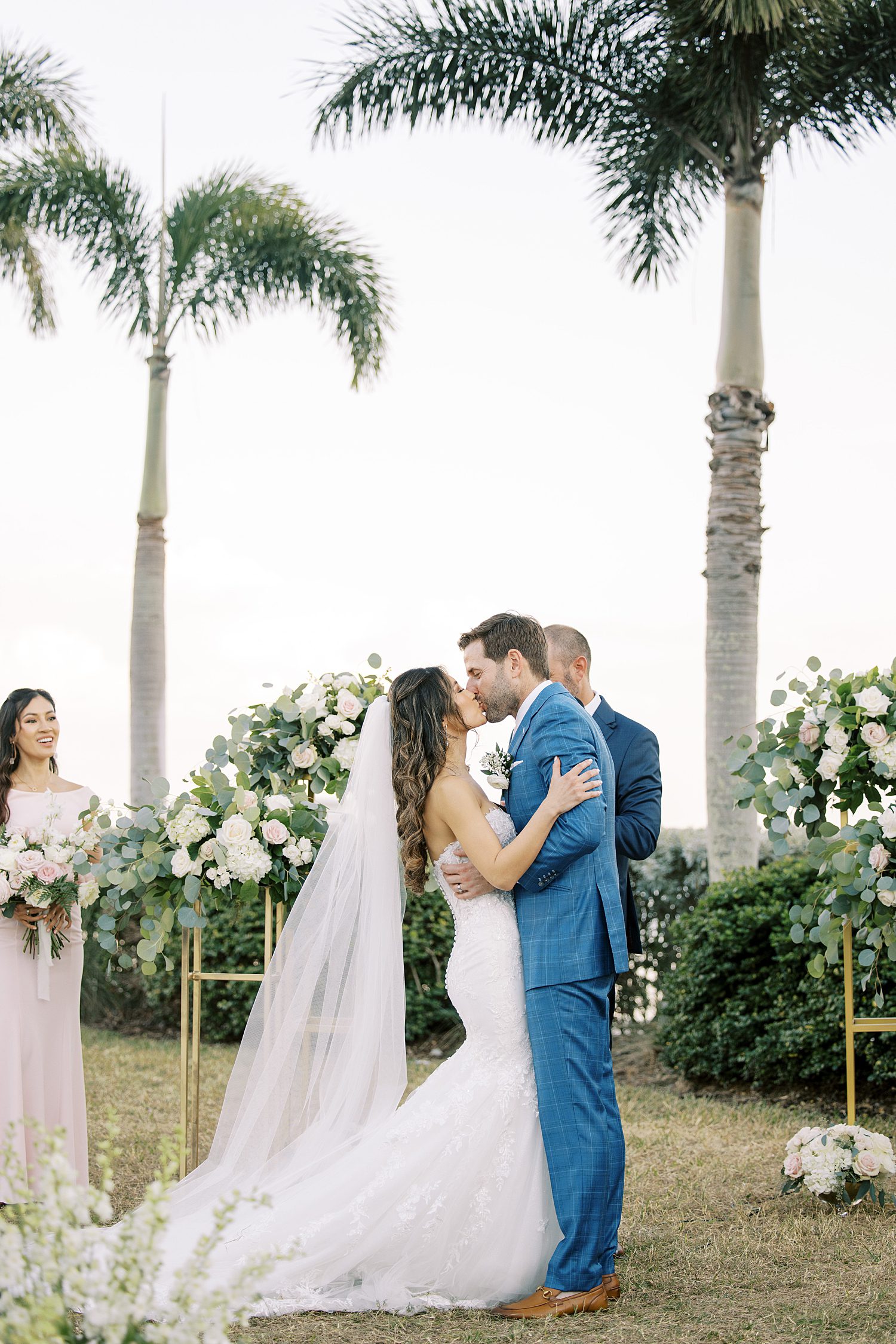 bride and groom kiss during wedding ceremony at Tampa Yacht Club