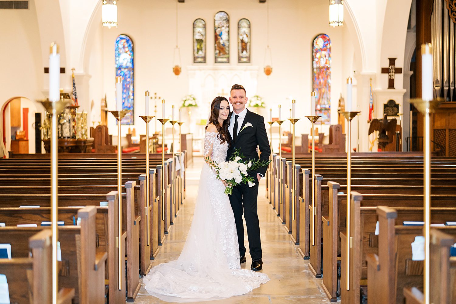 bride and groom hug in the aisle at St. Andrews Episcopal Church in Tampa FL