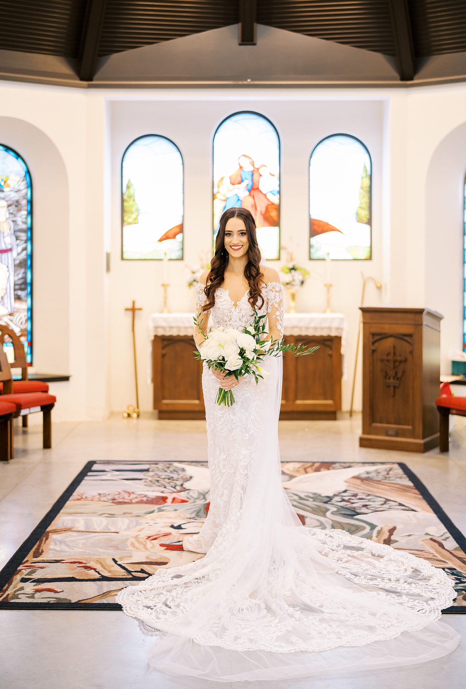 bride holds bouquet of white flowers inside Tampa FL church