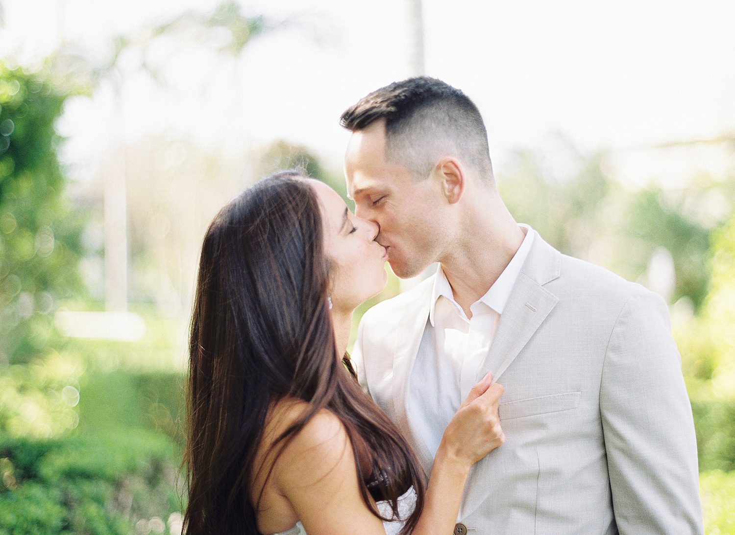 husband and wife kiss inside Hollis Gardens