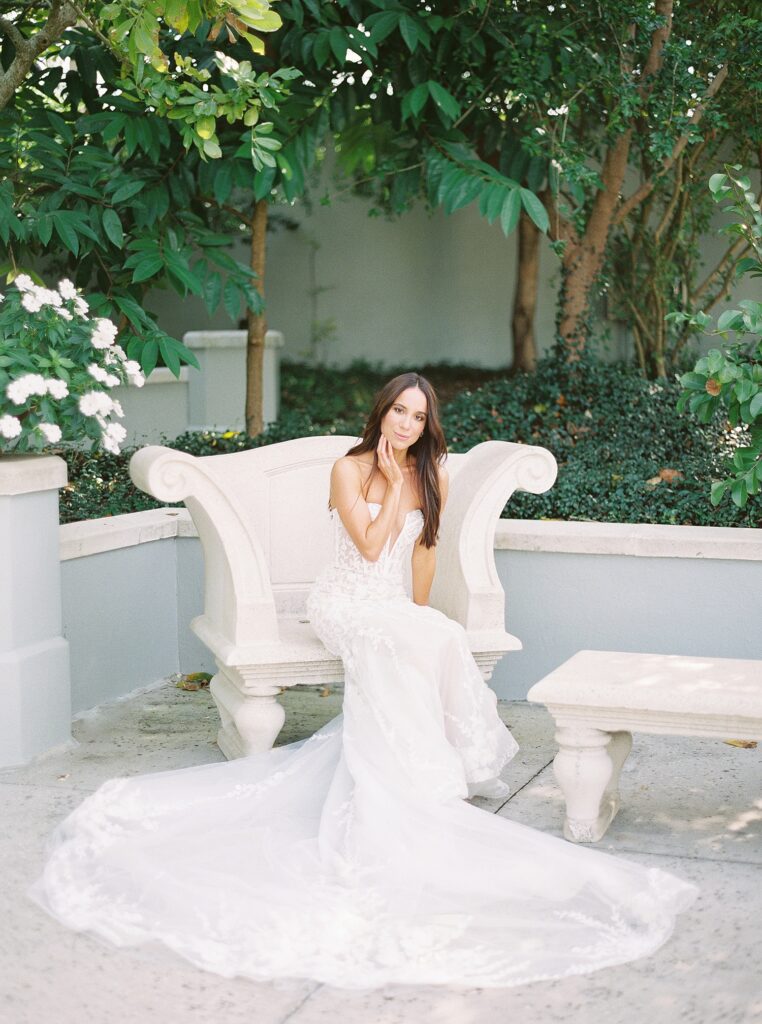 bride sits in couch on patio at Hollis Gardens
