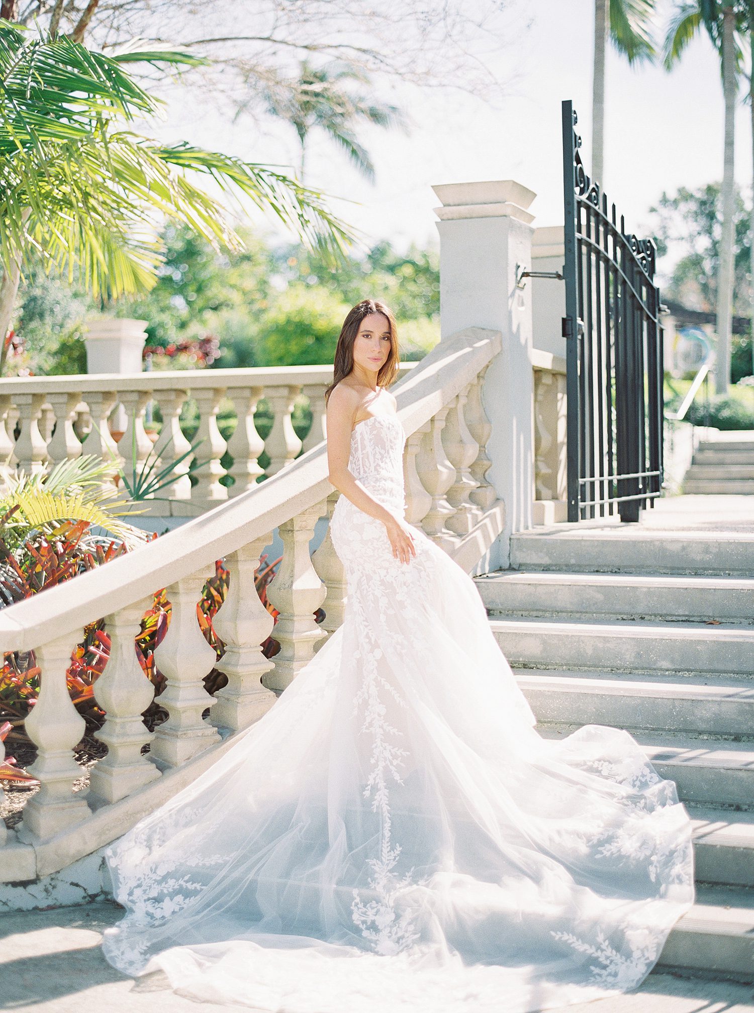 bride stands on steps inside Hollis Gardens