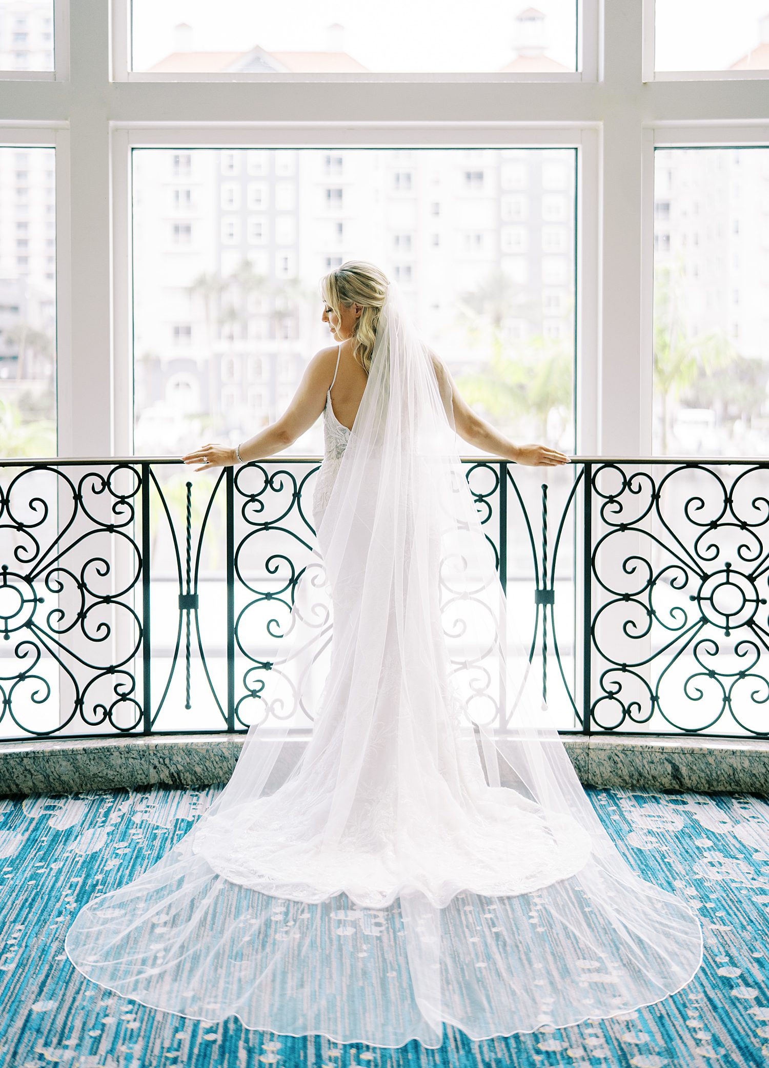 bride poses against metal railing inside Armature Works