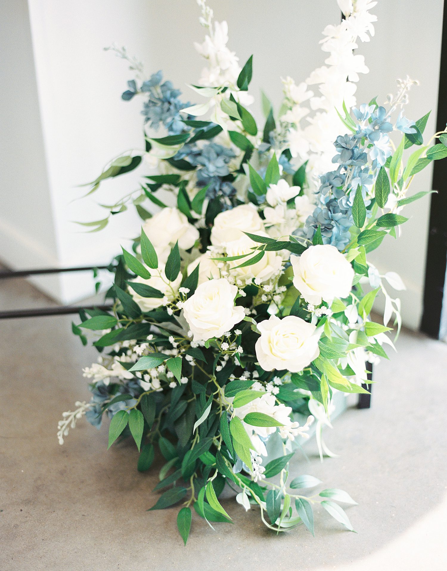 blue and white flower arrangement for edge of ceremony site