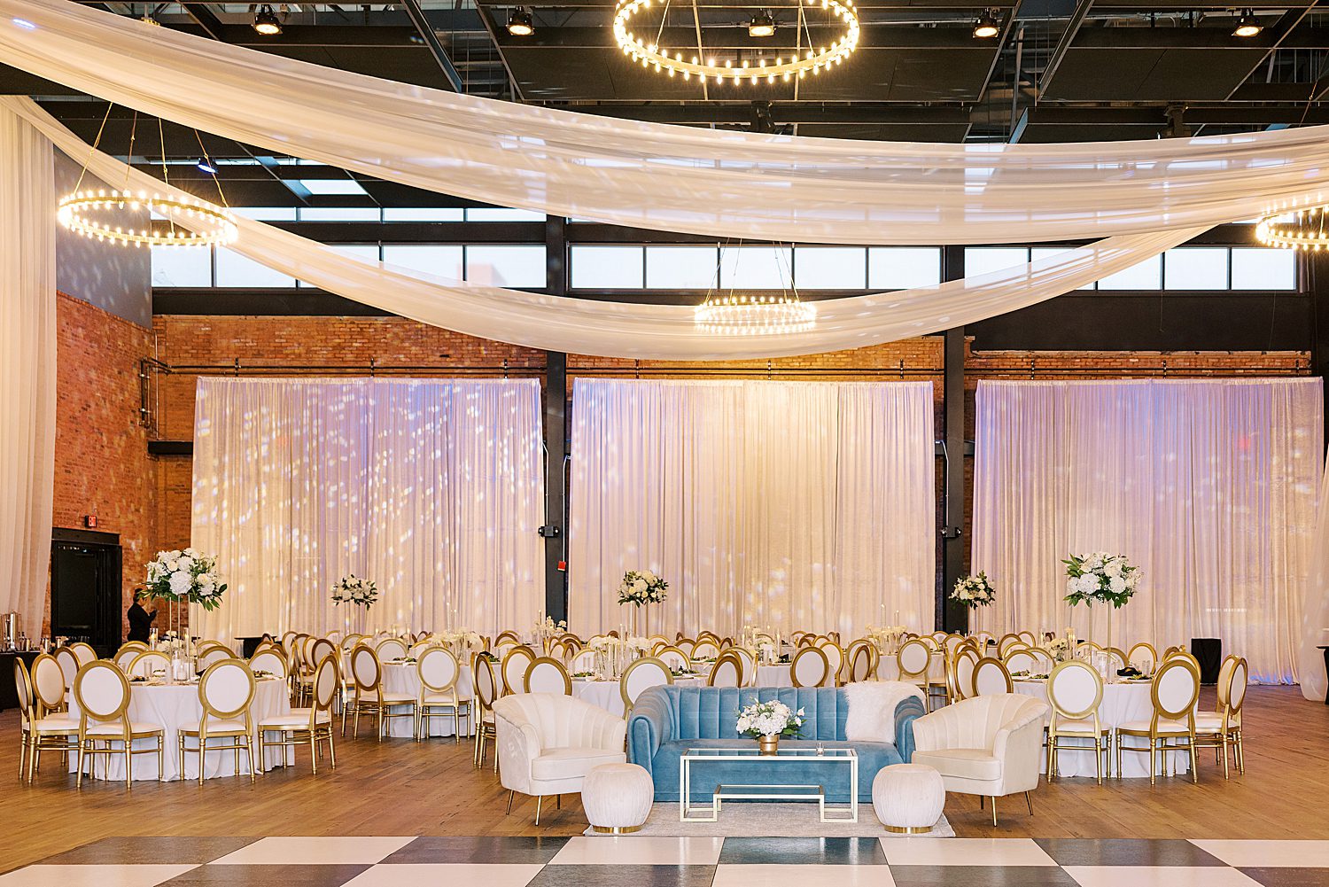 wedding reception with blue, white, and gold accents at Armature Works