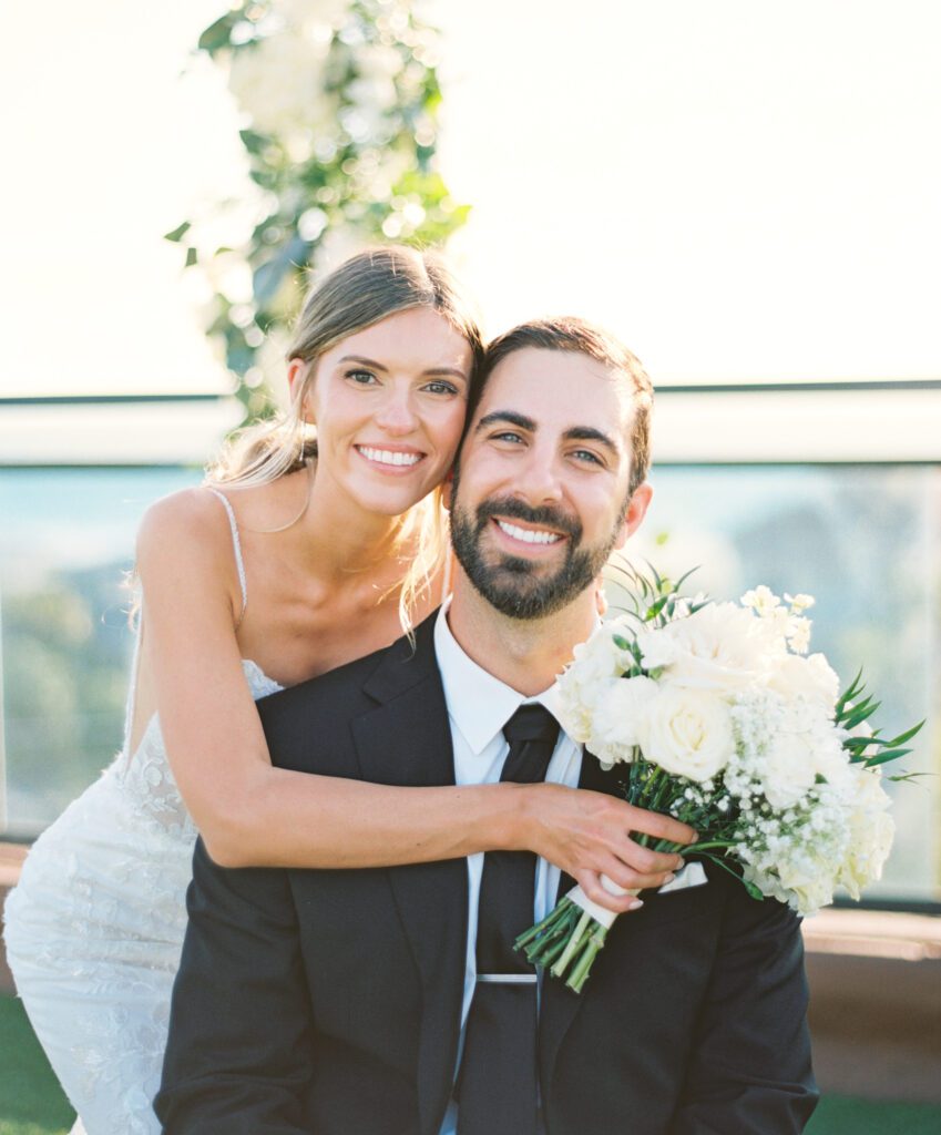 Bride and groom smiling at the camera during their wedding at hotel zamora