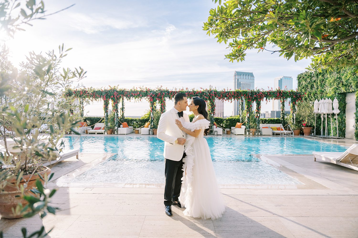 bride and groom hug near pool on rooftop of the Tampa EDITION hotel