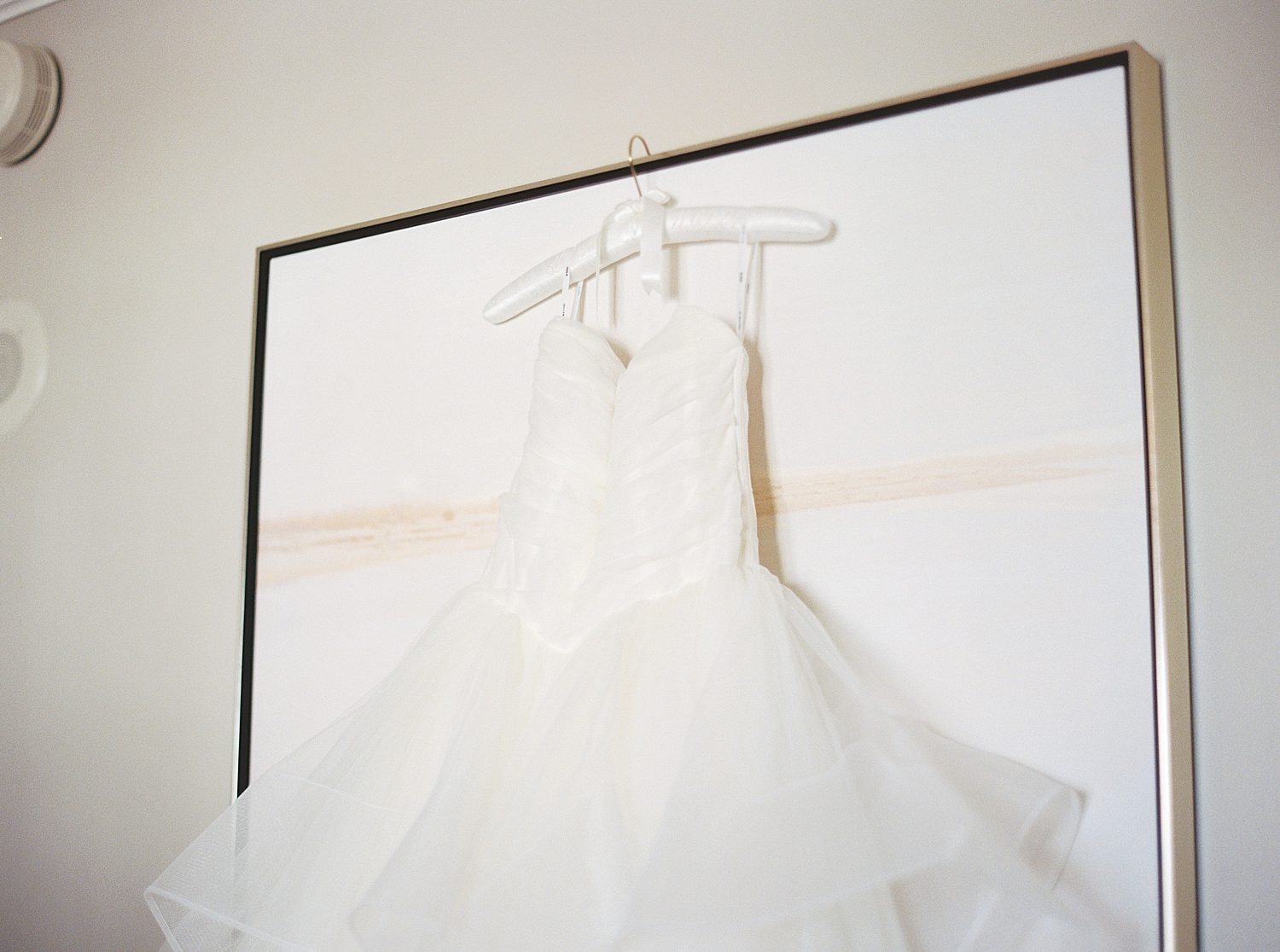 wedding dress hangs on artwork in the Ritz Carlton Sarasota