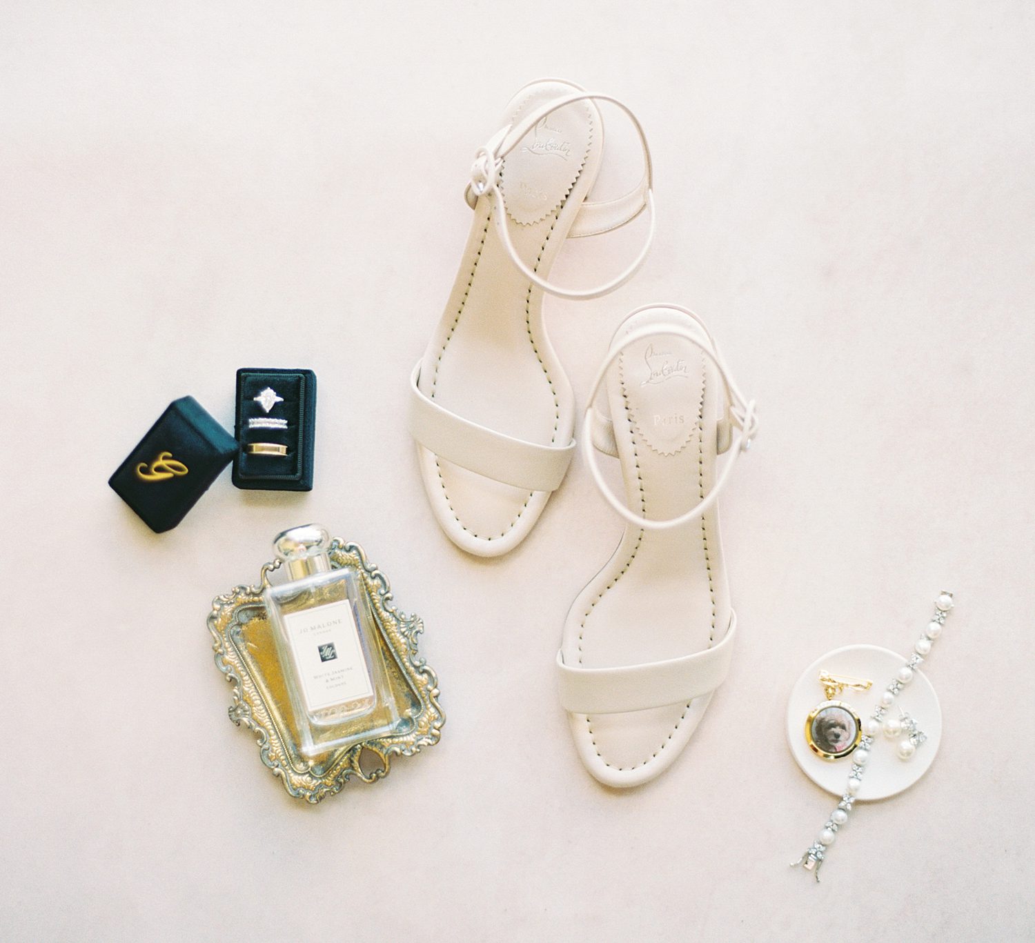 bride's ivory shoes, perfume, and rings