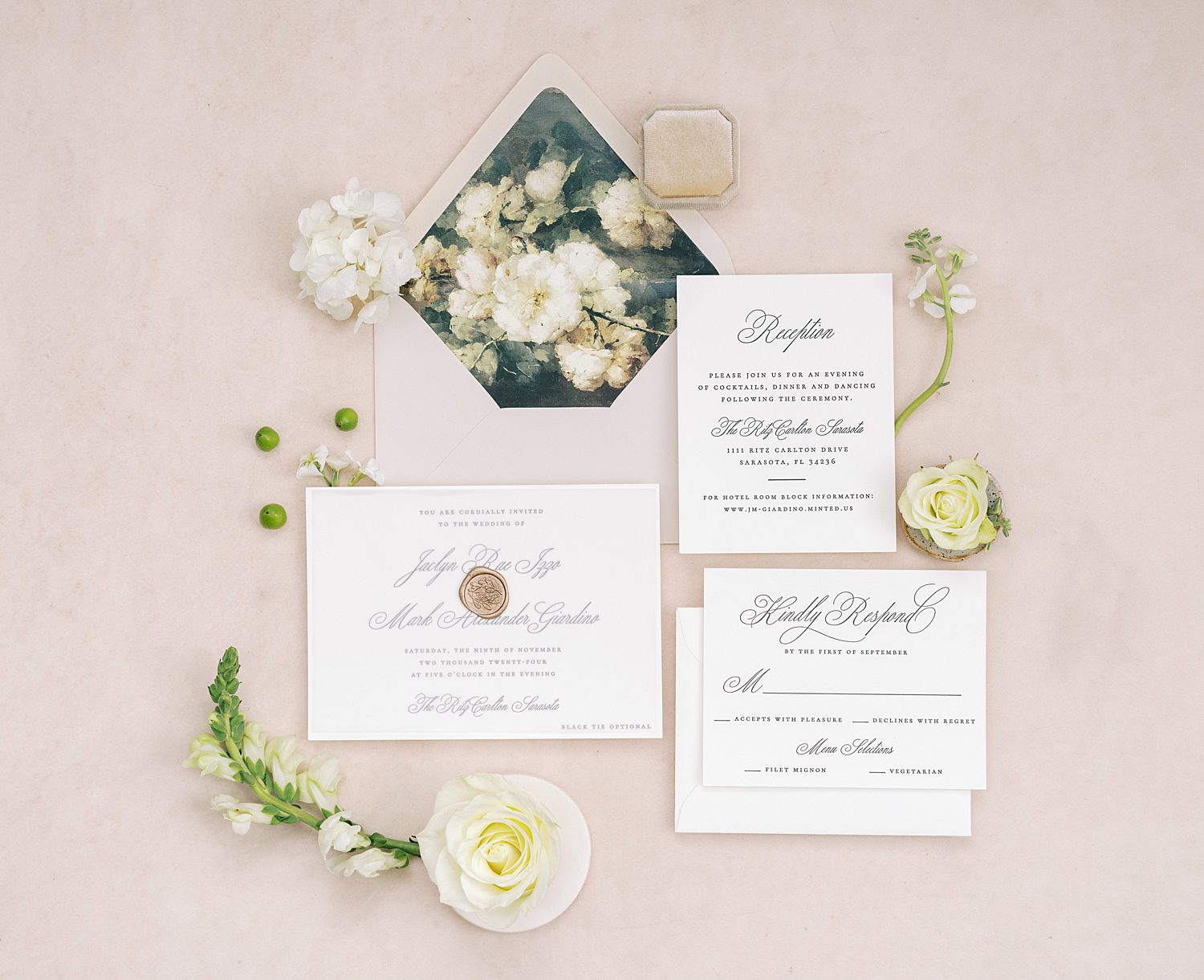 white and black classic invitation suite on pink board