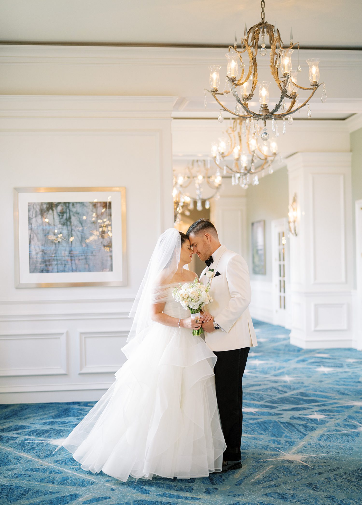 bride and groom hug in lobby of the Ritz Carlton Sarasota