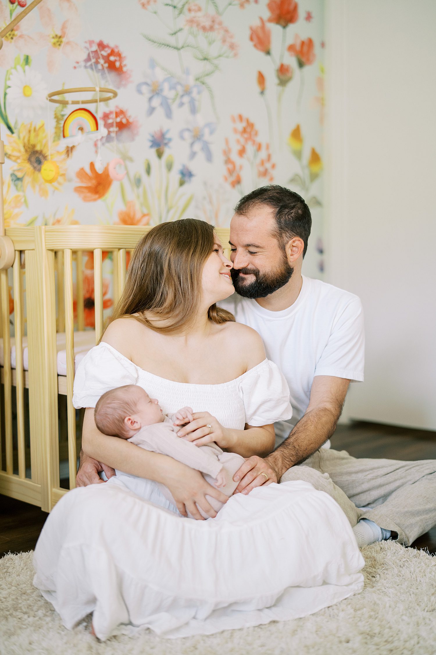 Tampa family photographer captures parents snuggling newborn daughter during newborn lifestyle photo session