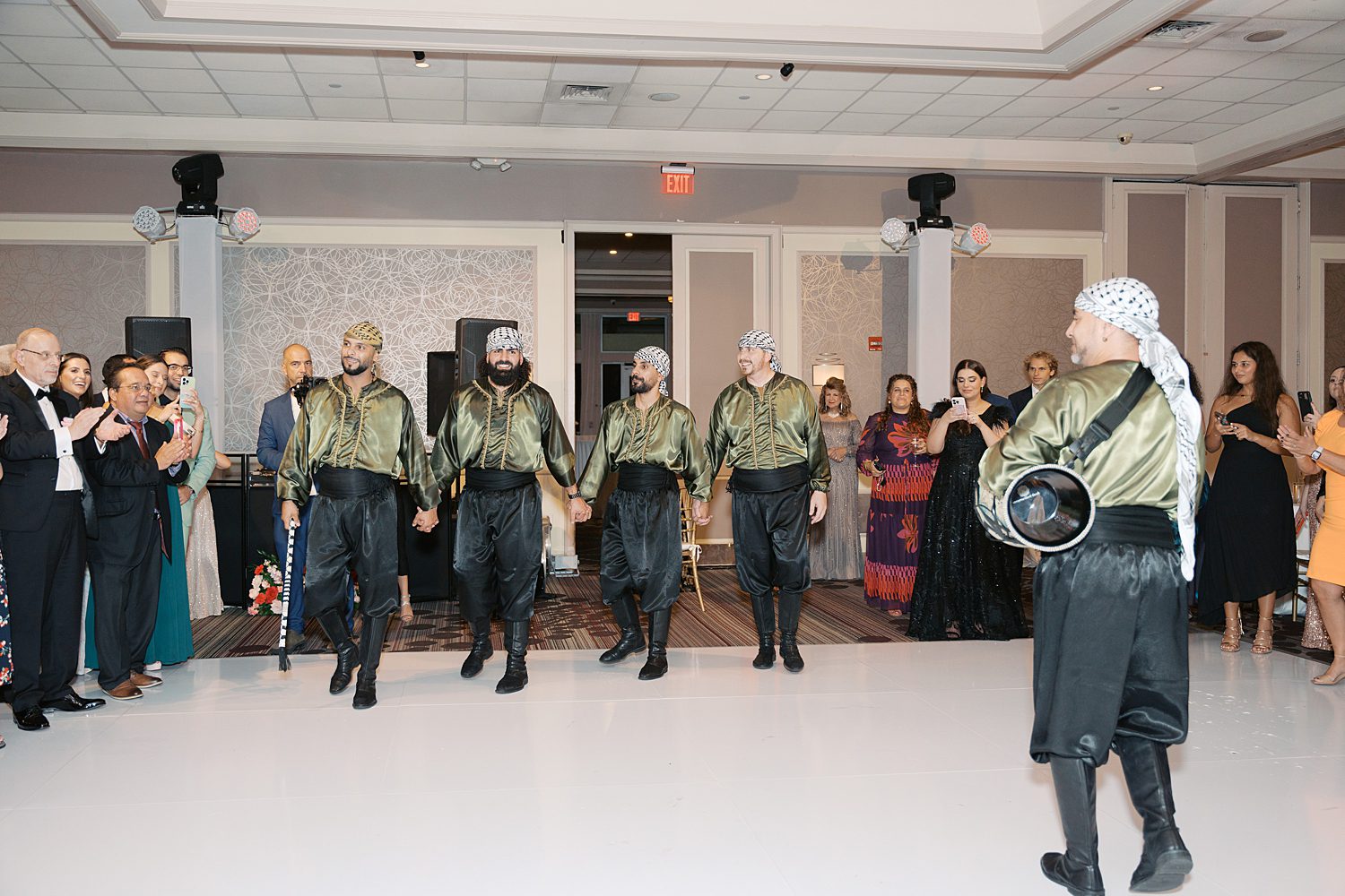 Al Fursan and Dabke performers stand in line on reception floor