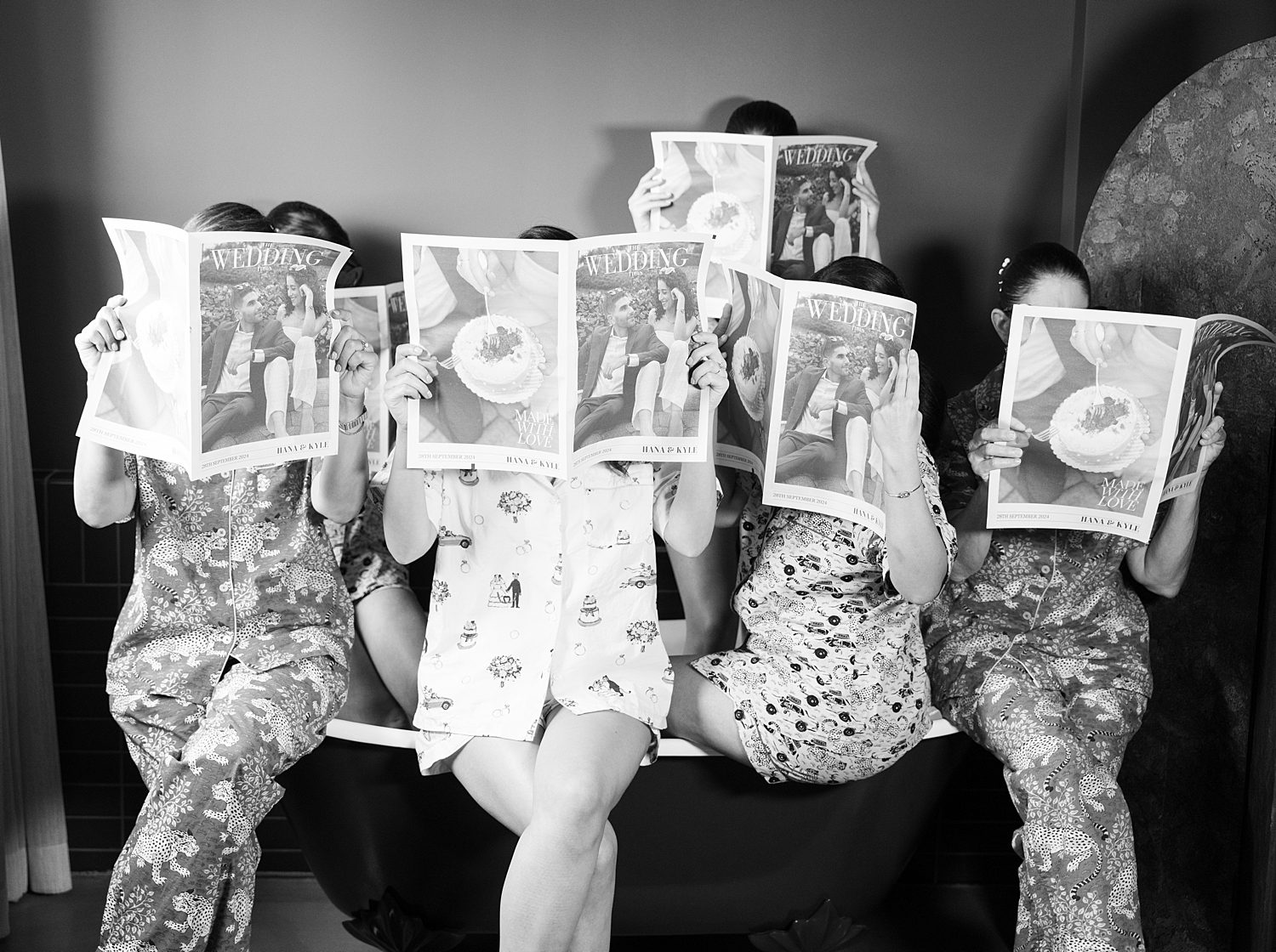 bride and bridesmaids hold up newspapers at the Mayfair House Hotel