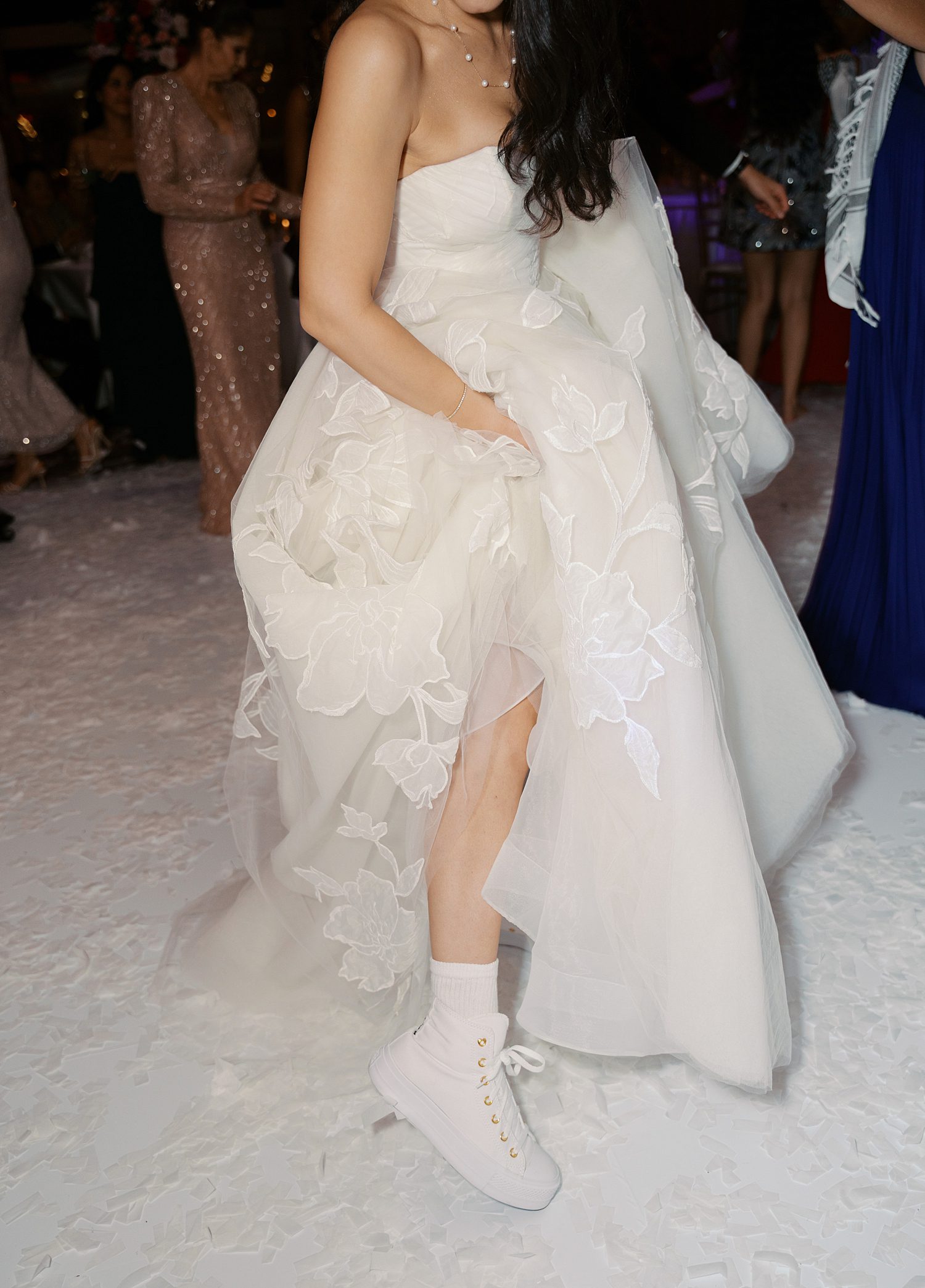 bride shows off white shoes under wedding dress at the Rusty Pelican Miami