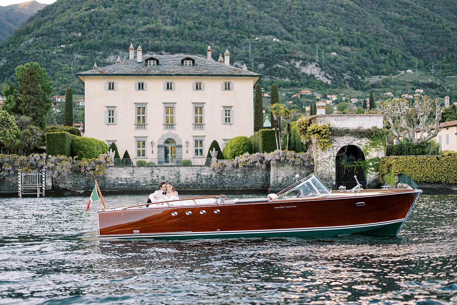 couple rides on boat on Lake Como during Italy wedding