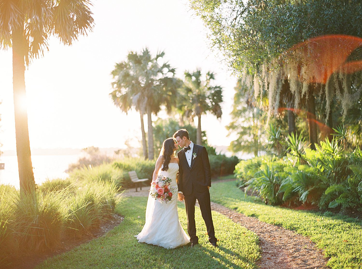 bride and groom kiss among palm trees at Stonelake Ranch