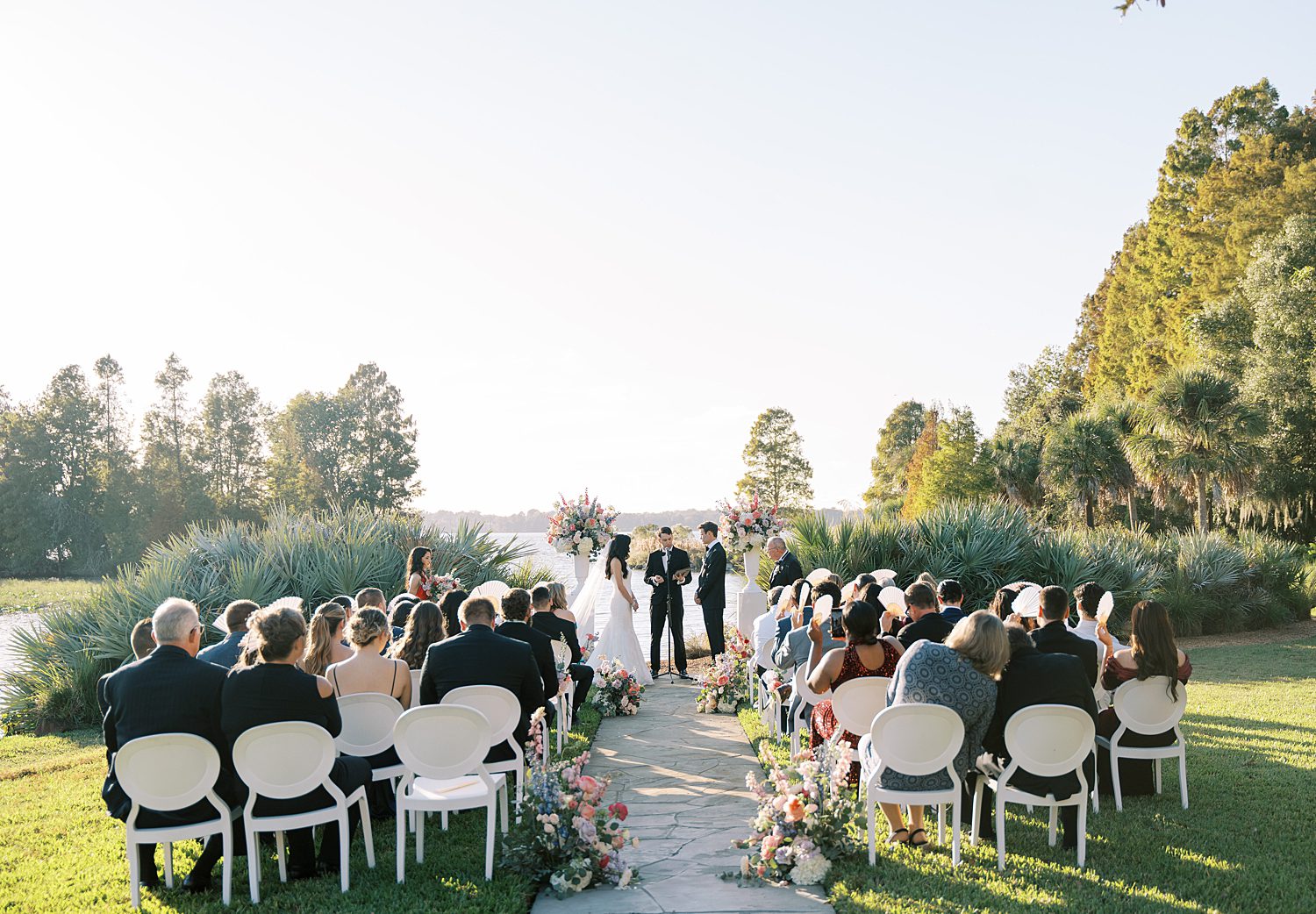 wedding ceremony on lawn by lake at Stonelake Ranch