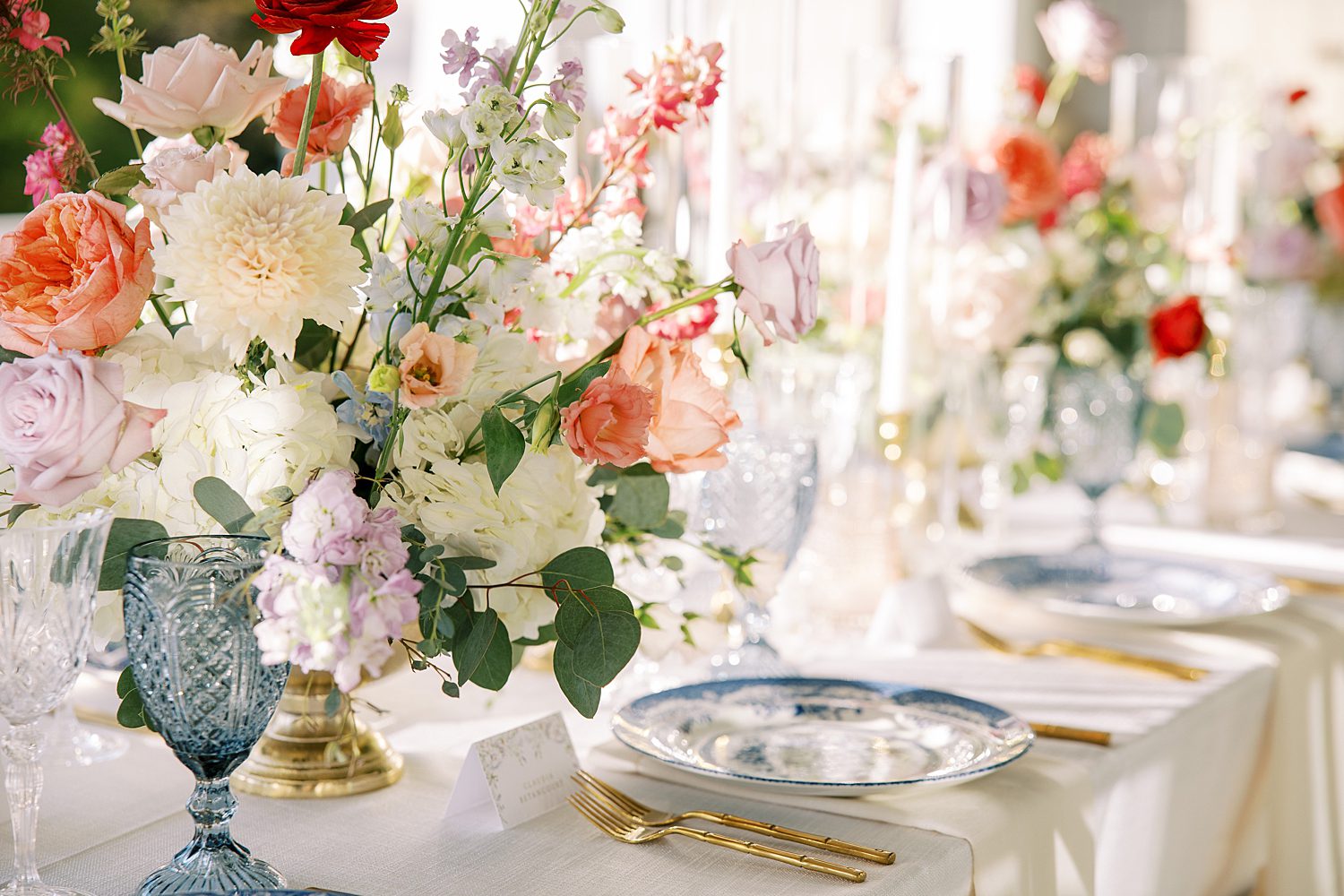 wedding reception with pink and white flowers and blue and white plates