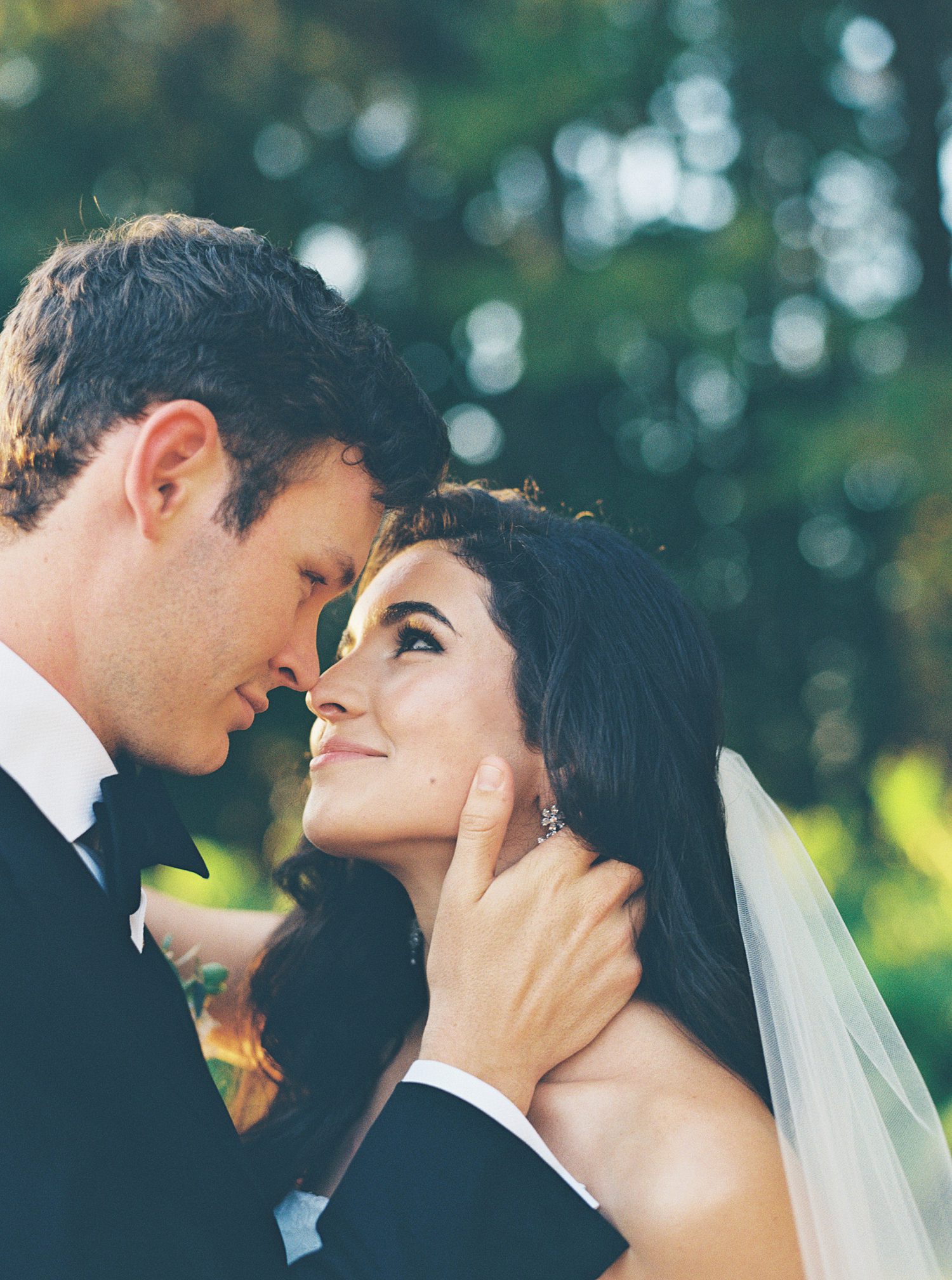film photo of bride and groom leaning heads together 