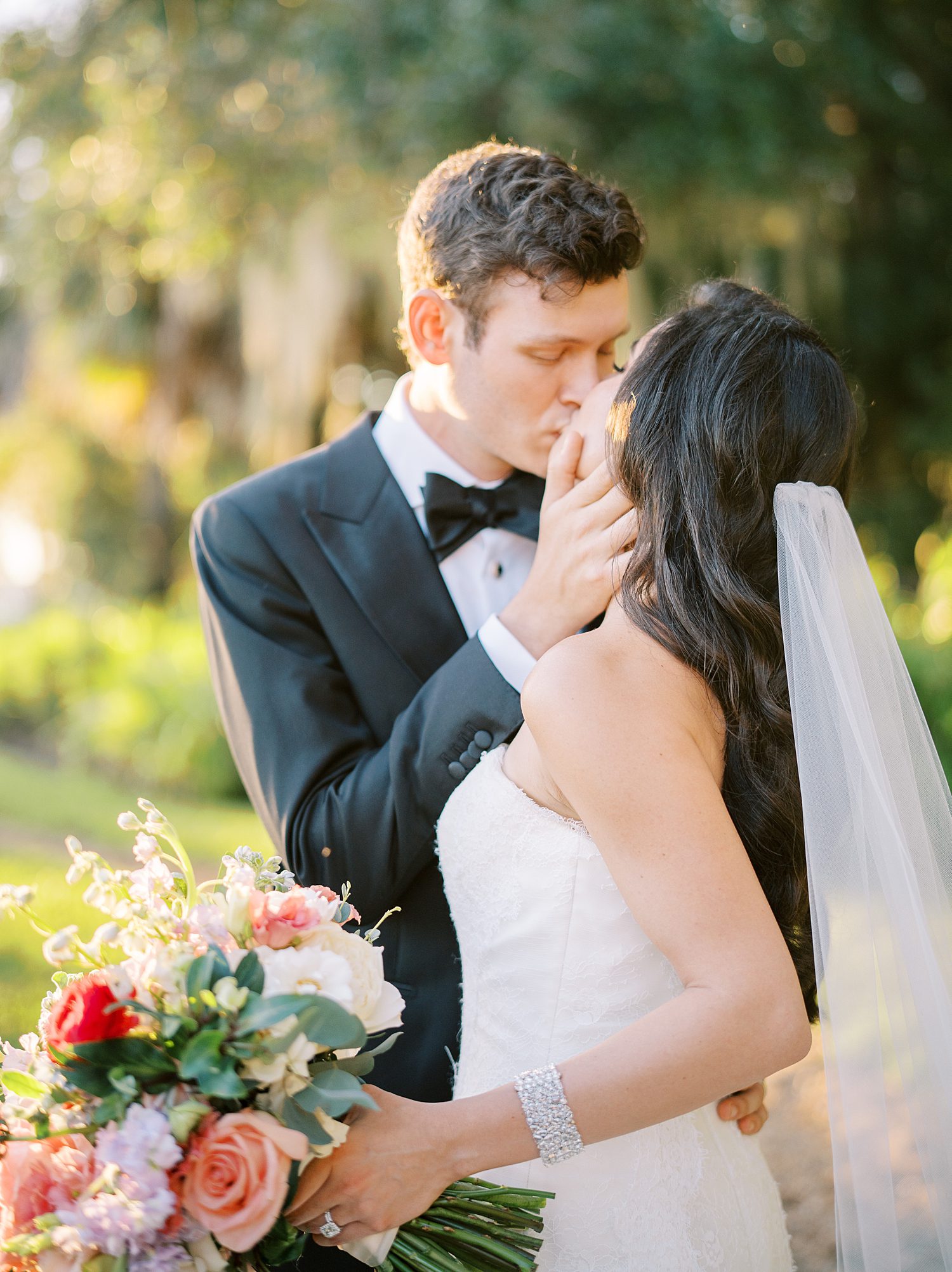 groom kisses bride holding her close at Stonelake Ranch