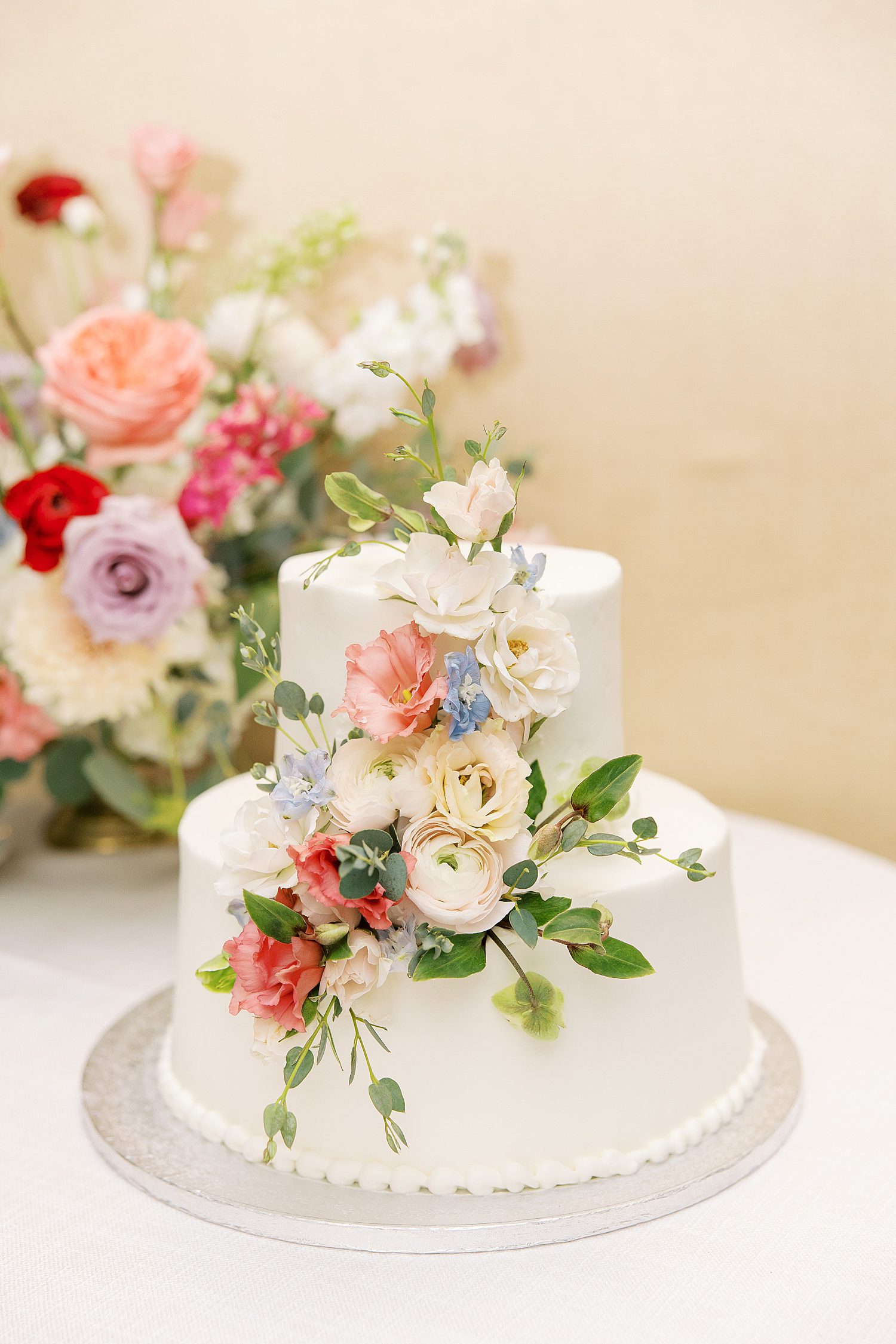 tiered wedding cake with pink and white flowers