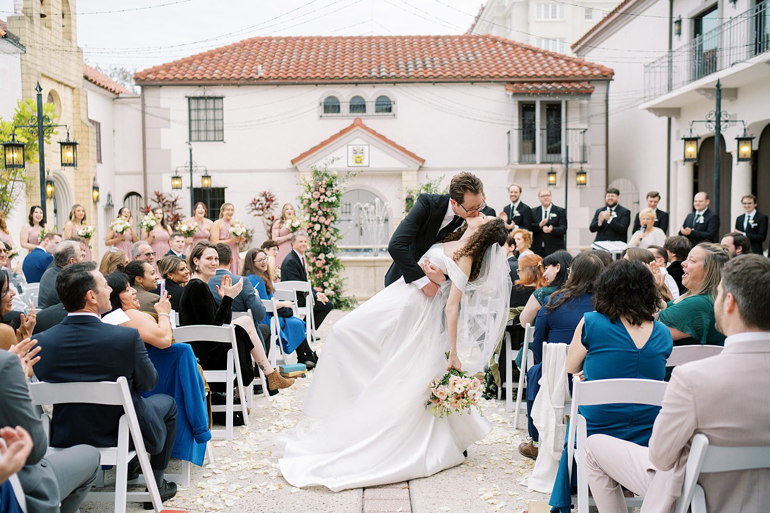 bride and groom kiss in aisle of ceremony at the Bishop Museum of Science and Nature