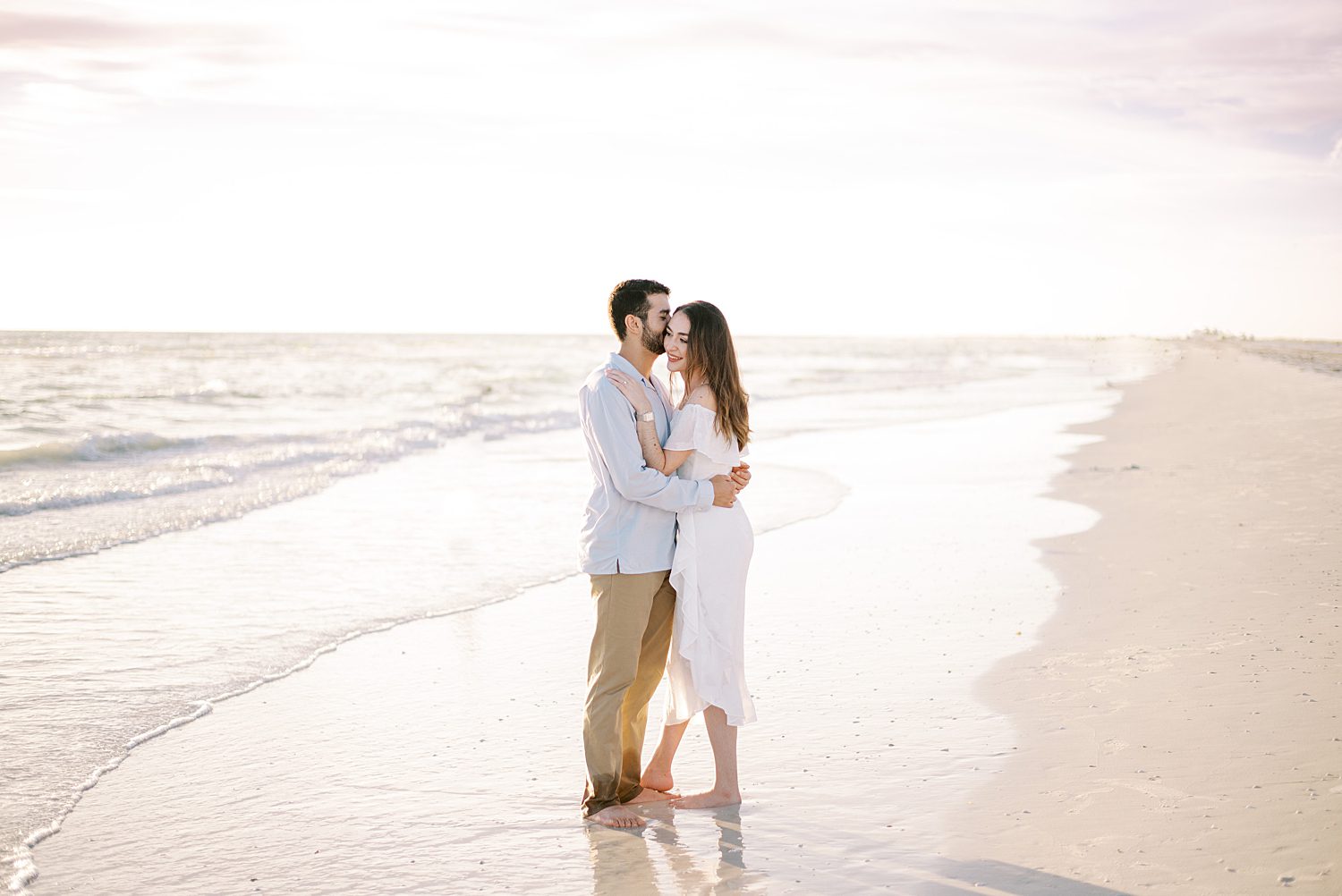 couple hug on the beach after wedding ceremony in FL 