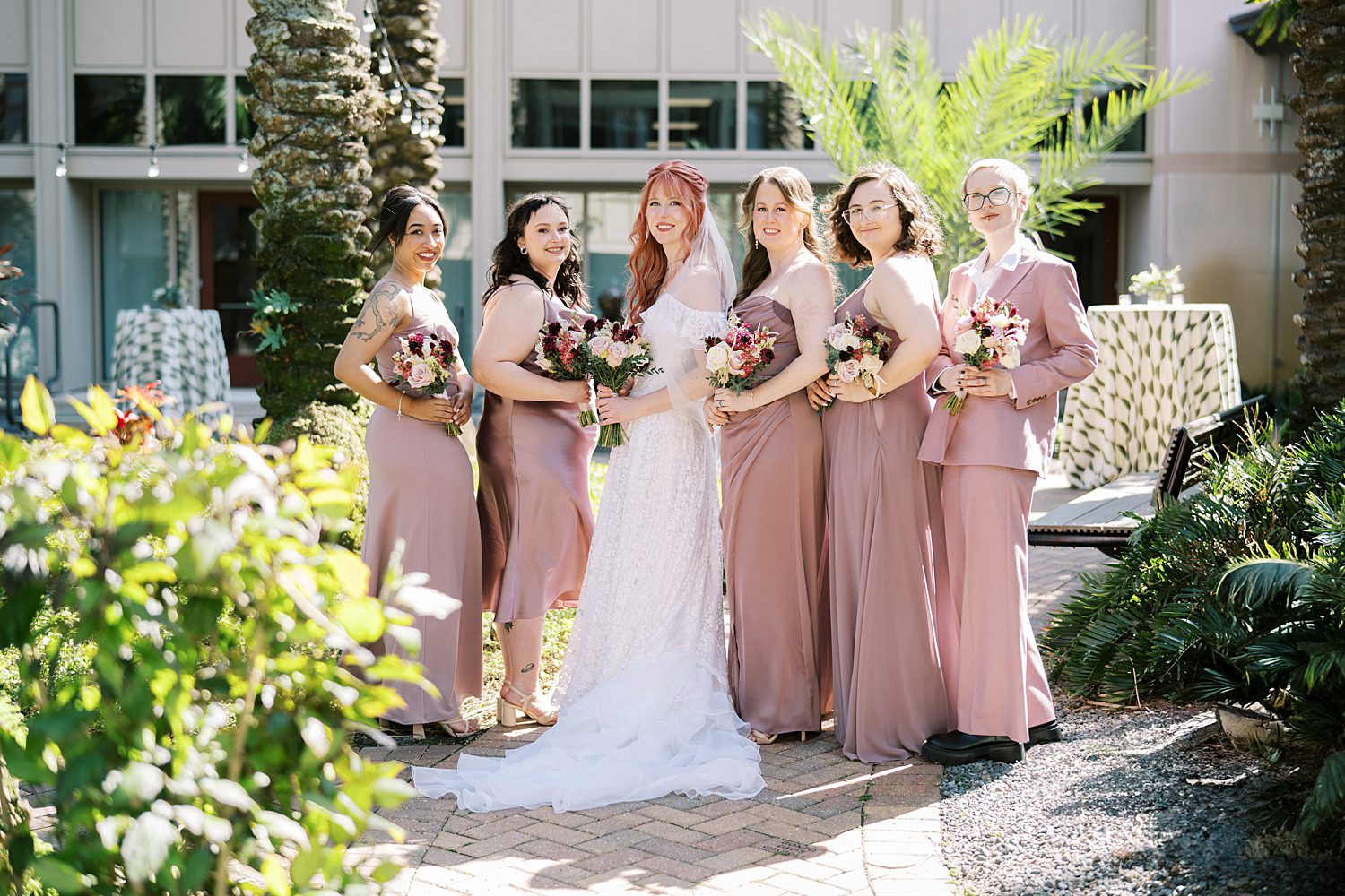 bride and bridesmaids in soft pink dresses