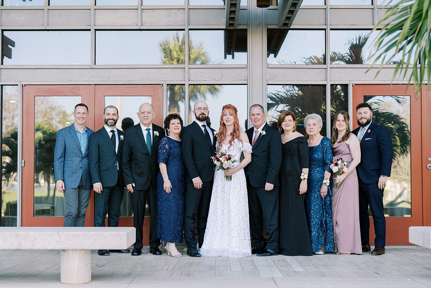 newlyweds with family outside of The Poynter Institute  