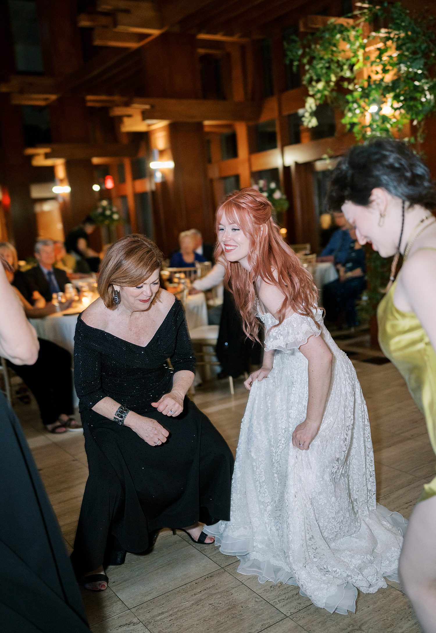 bride on dance floor with loved ones 