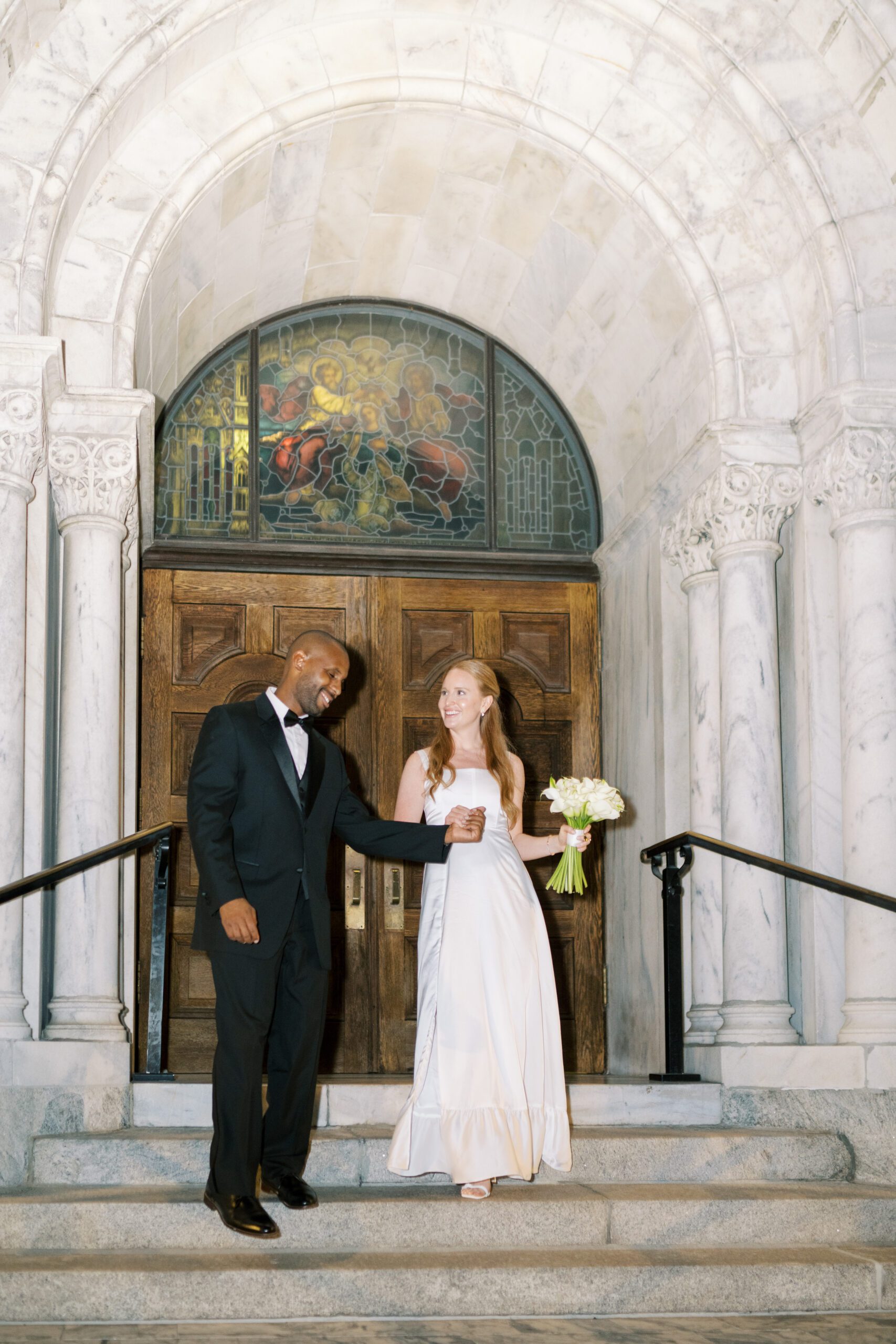newlyweds outside of Catholic church in Tampa