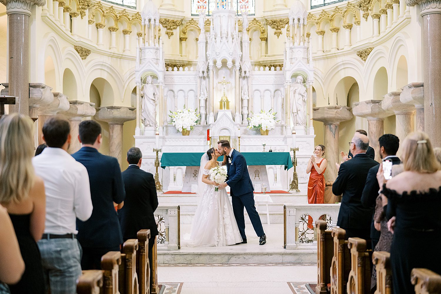bride and groom kiss at Sacred Heart Church Wedding 